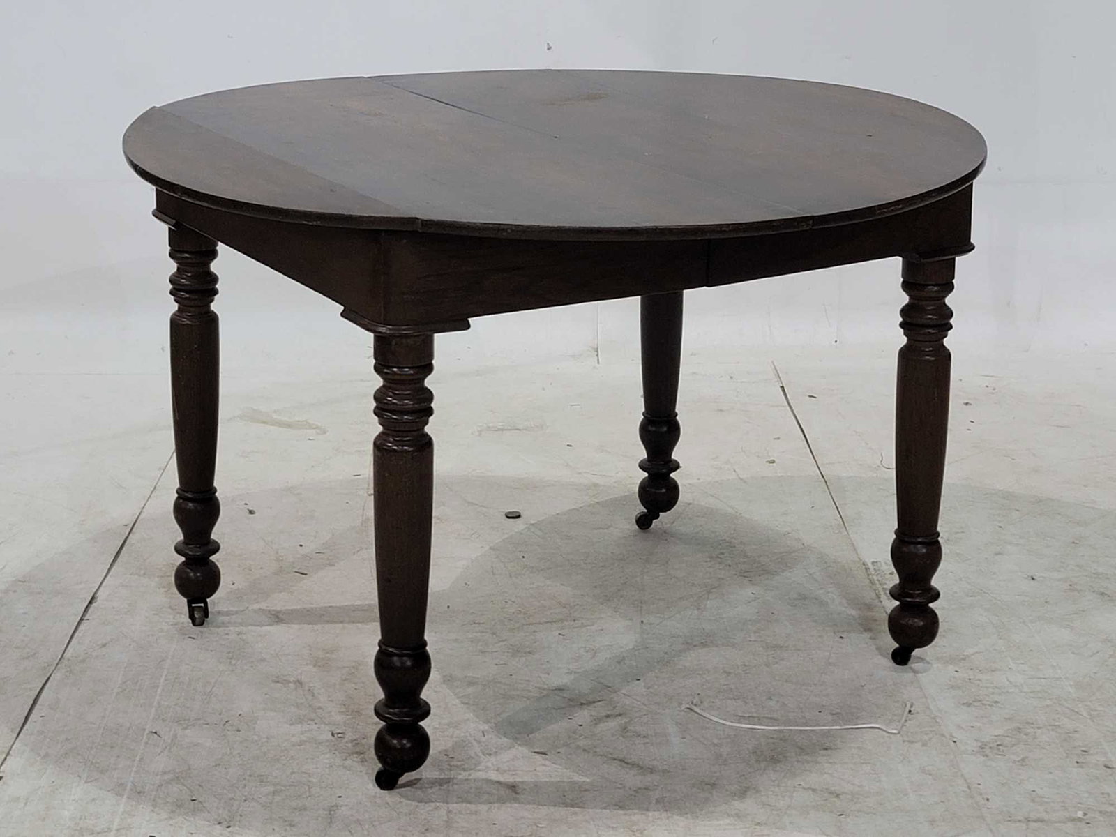 Dining Table: Dining table on casters height 29 in. x diameter 45 in. We happily provide seamless shipping services on everything we sell. Please email us at shipping@vogtauction.com or call 210-971-5750 for mo
