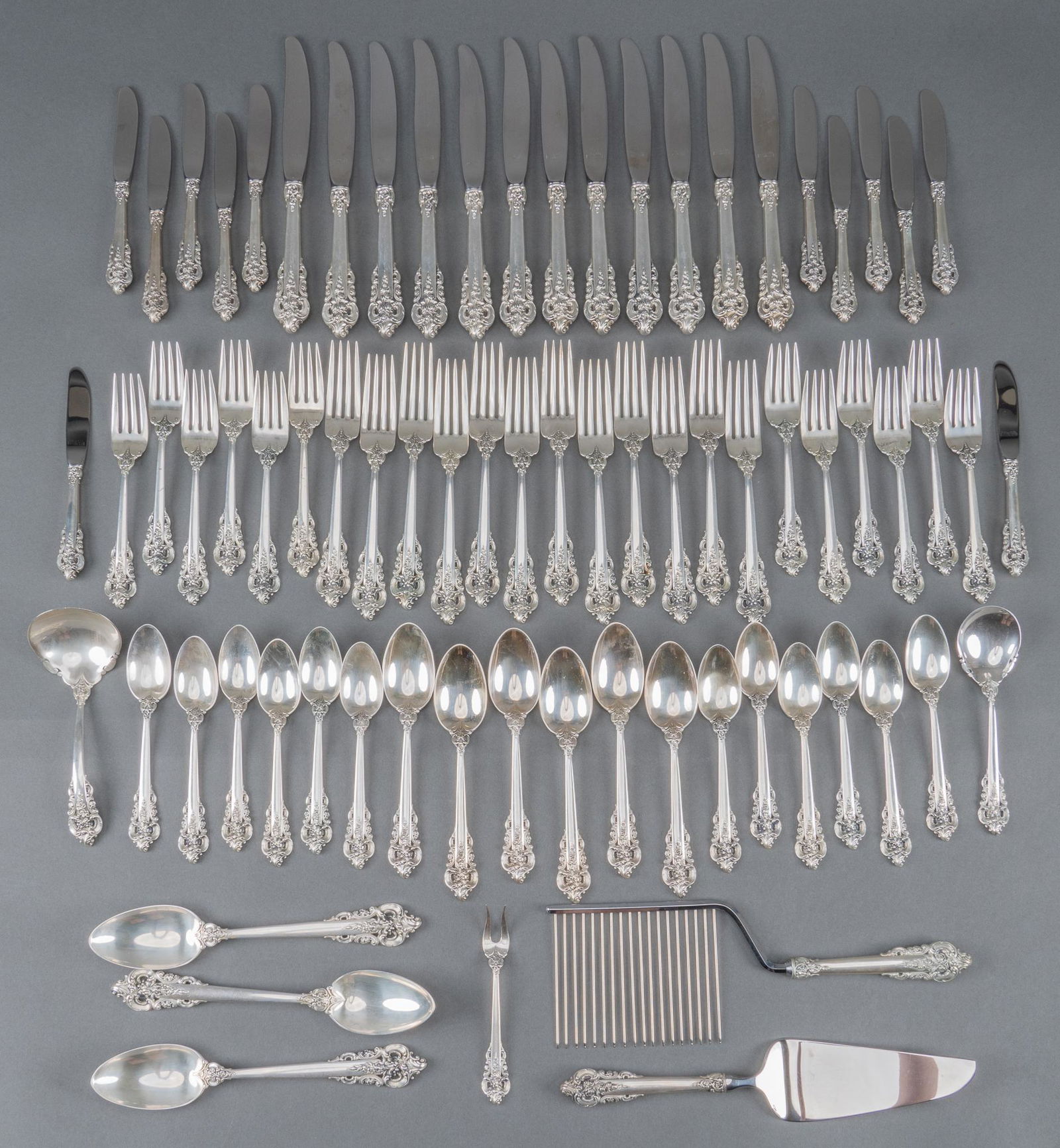 "Grande Baroque" by Wallace Silversmiths Sterling Flatware Set: "Grande Baroque" by Wallace Silversmiths sterling silver flatware service of 74 pc.; no monogram or removal. Includes: 12 dinner knives 8 7/8 in. 12 dinner forks 7 1/2 in. 11 salad forks 12 t