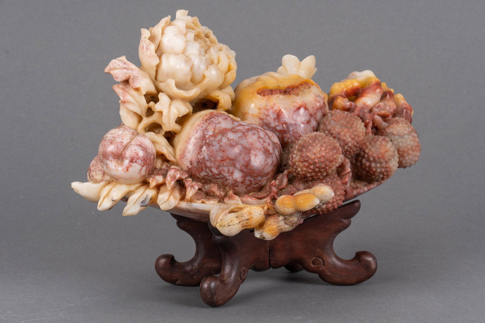 Chinese Carved Soapstone Fruit and Flowers Sculpture: Reticulated, fully dimensional fruit and flowers carved of cream to sienna gradient soapstone. Length 11 1/4 in., height 7 3/4 in. Provenance: An Oklahoma City, Oklahoma corporate collection We happil