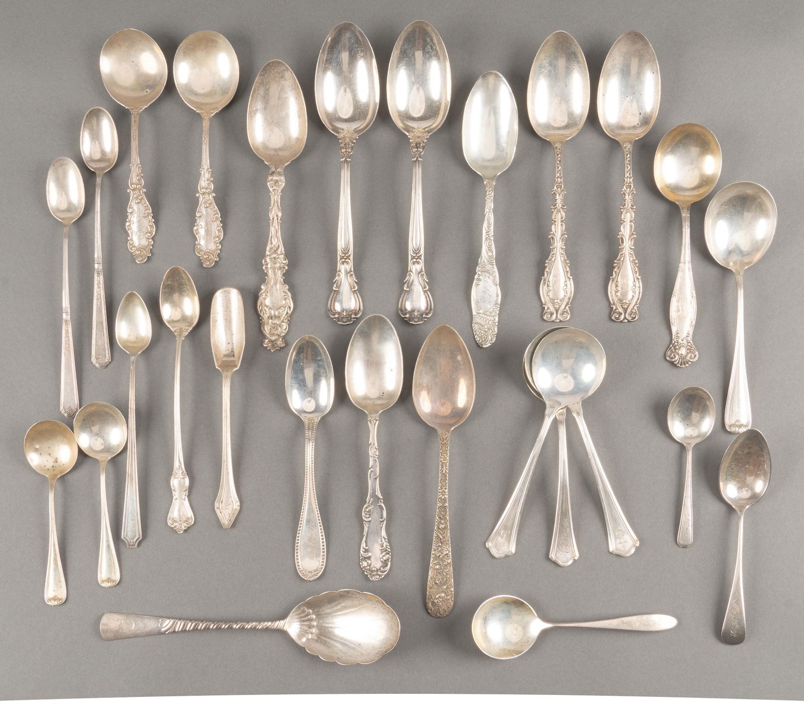 Collection of Sterling Silver Place Setting Spoons: Collection of sterling silver (mostly singles) iced tea, soup, table and bouillon spoons which include "Lily" by Whiting Co, "Washington" by Wallace Silversmiths, "Repouss" by
