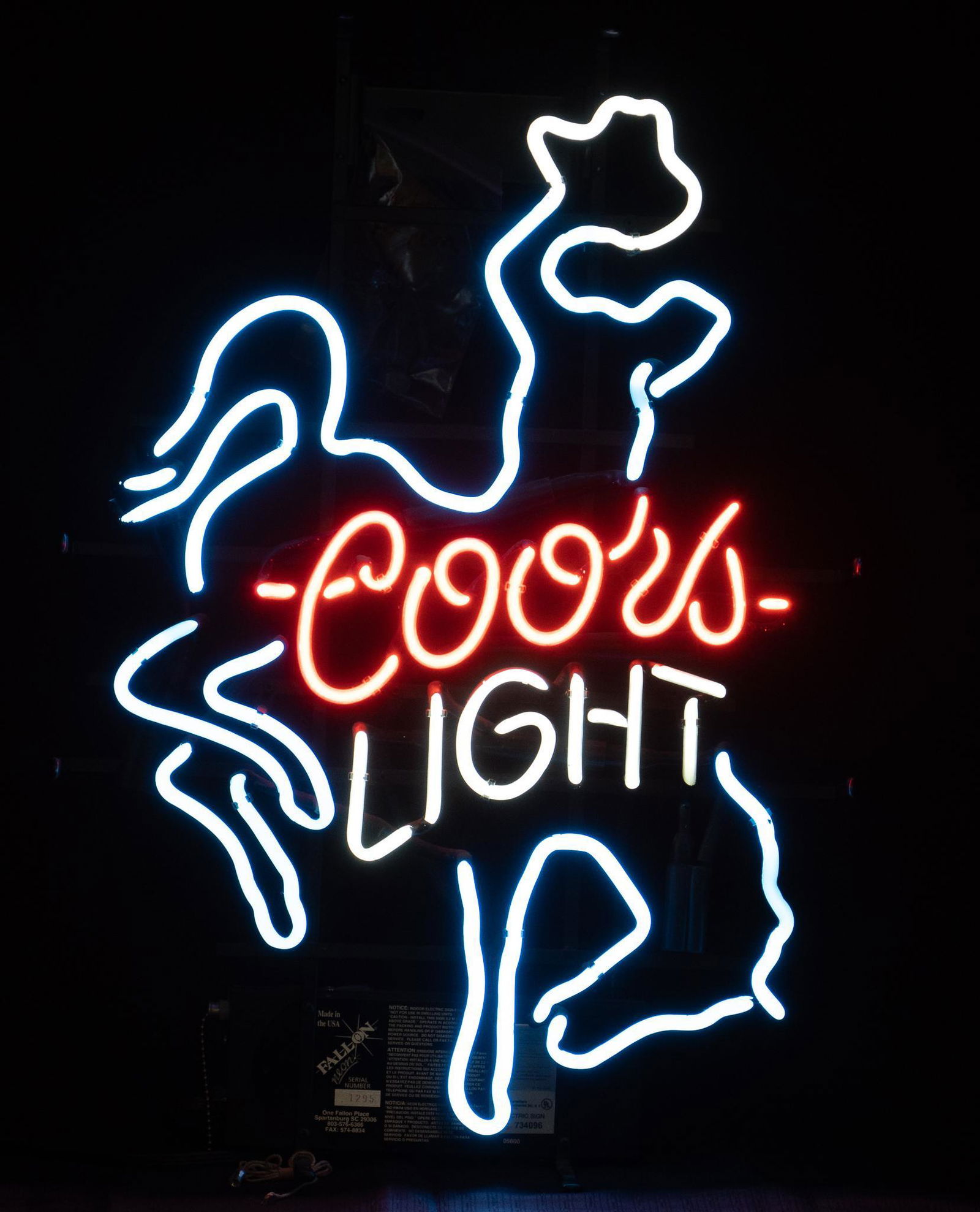 Coors Light Cowboy Neon Sign: Coors Light Beer neon advertising bar sign, having cowboy on bucking horse motif, stylized lettering reading "Coors Light", supported on metal stand, wiring in working condition height 25 in
