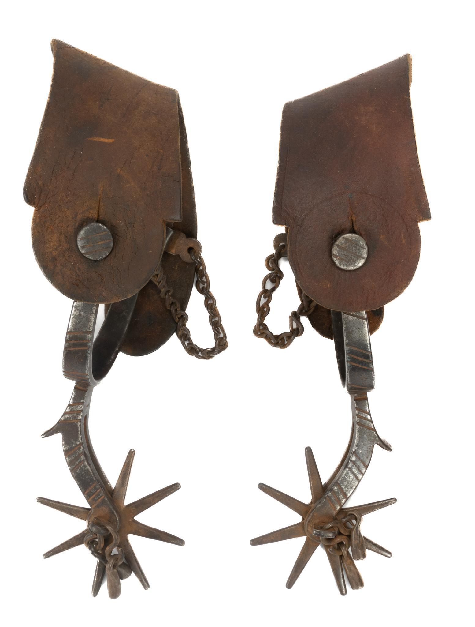 Pair of Sonoran Spurs: Pair of large Sonoran jingle bob spurs, having leather straps, steel bands, featuring engraved triple strike motif 3"h x 9"w x 4"d €â€¹€â€¹€â€¹€â€¹&euro