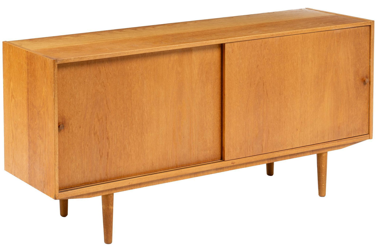 Danish Mid-Century Sideboard: Danish Mid-Century teak sideboard with left and right sliding doors each opening to interior storage with an adjustable shelf, supported on pin legs height 29 in. x width 62 in. x depth 15.5 in. We ha