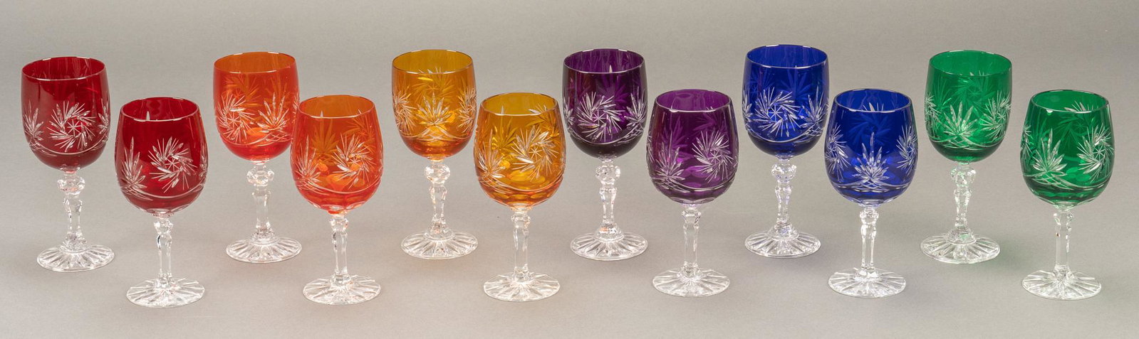 Set of (12) Cut to Clear Wine Glasses and Goblets: Set of six cut to clear wine glasses and six cut to clear goblets, with colors purple, blue, red, orange, yellow, green, one of each color for the wine glasses and goblets, "olive grinder" pat