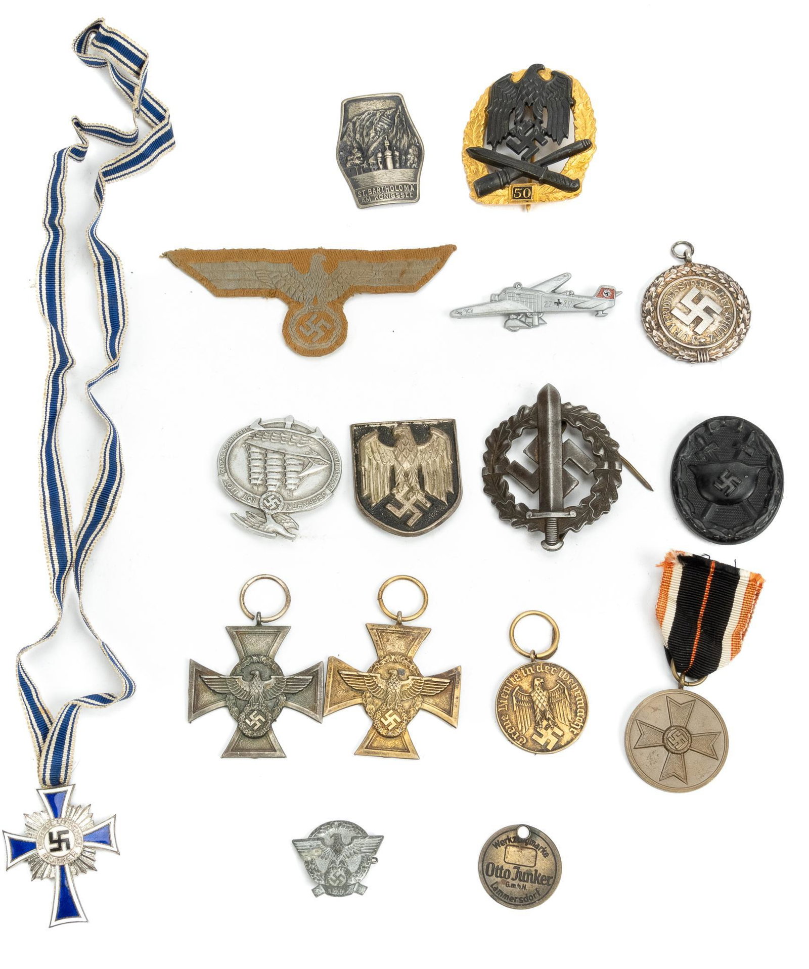 Collection of German WWII Militaria: Includes: -1939 War Merit medal; SA sports badge by Redo; Legion Condor Wound badge; 18 Year Police Long Service medal; 25 Year Police Long Service medal; Repro 50 General Assault badge; "SEEFAHRT