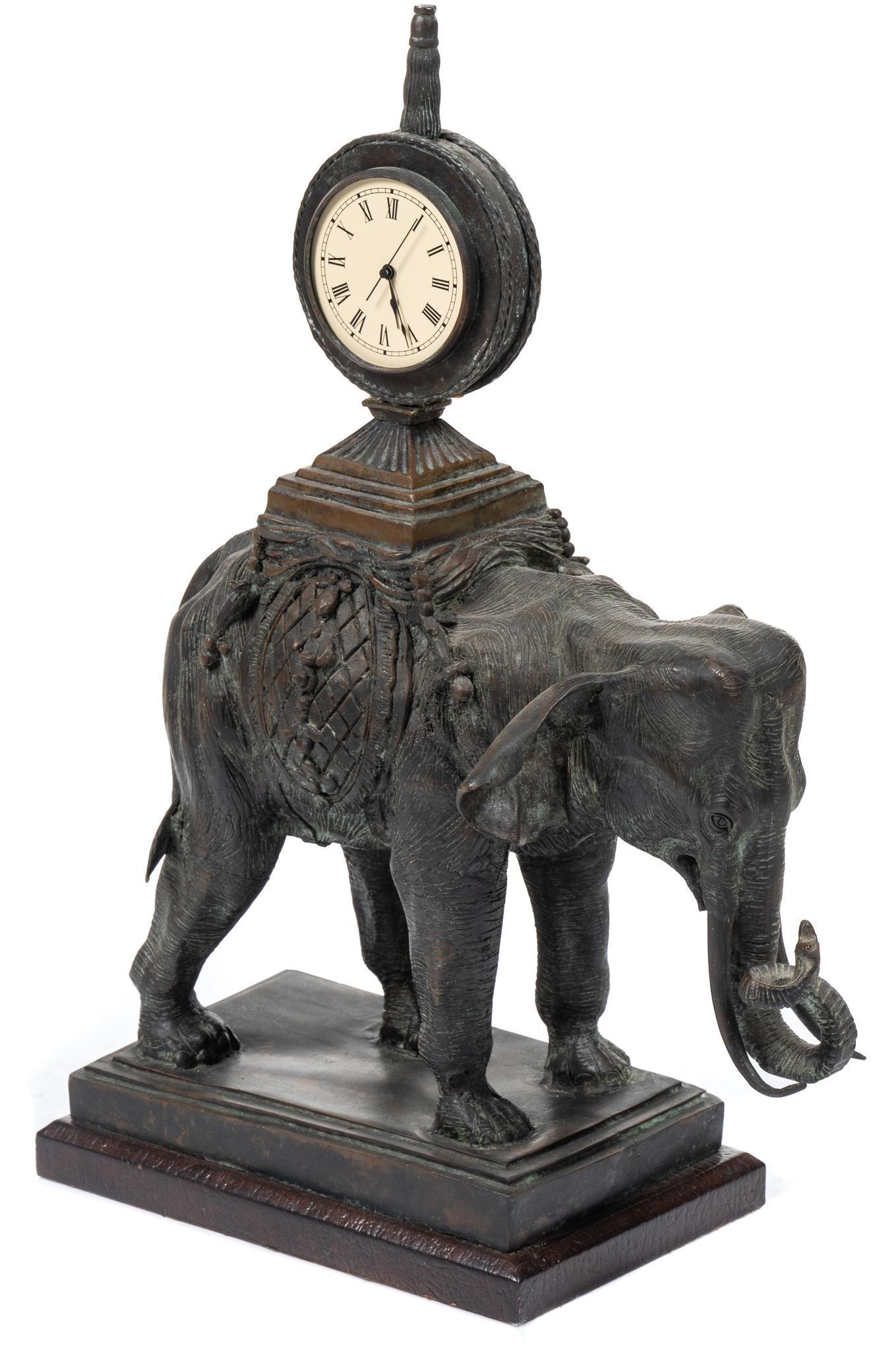 London Explorerâ‚¬â„¢s Club Bronze Elephant Table Clock: London Explorer€â„¢s Club bronze figural table clock with elephant supporting clock, all on a rectangular base height 24 in. x width 18 in. x depth 8 in. Provenance: The Estate of Ed Varela, 
