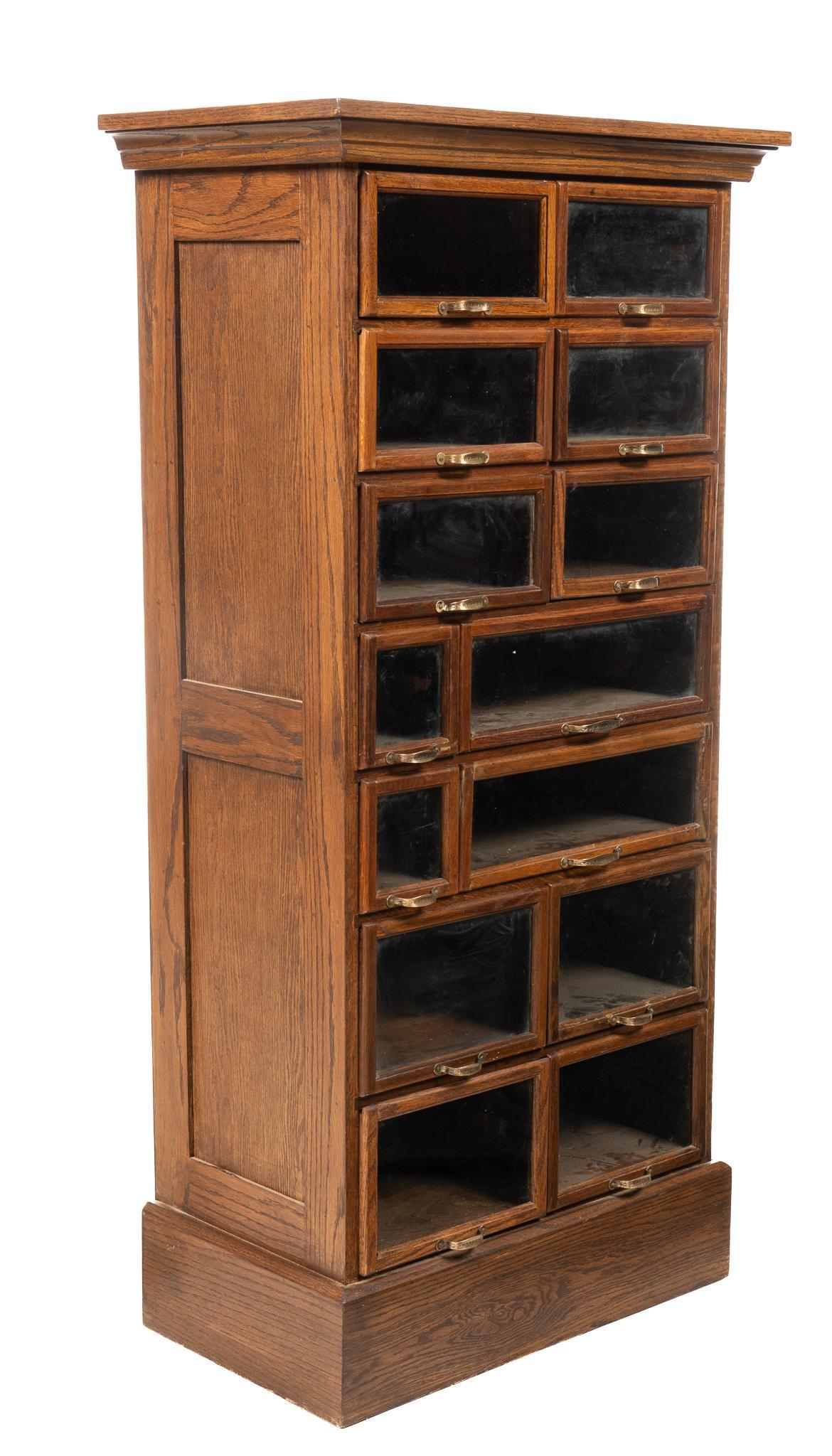 J.D. Warren Manufacturing Co. Display Cabinet: J.D. Warren Manufacturing Co. (Chicago, USA) display / haberdashery cabinet, with fourteen glass front drawers of various sizes, with brass handles marked Warren, circa late 1800s height 60 in. x wi