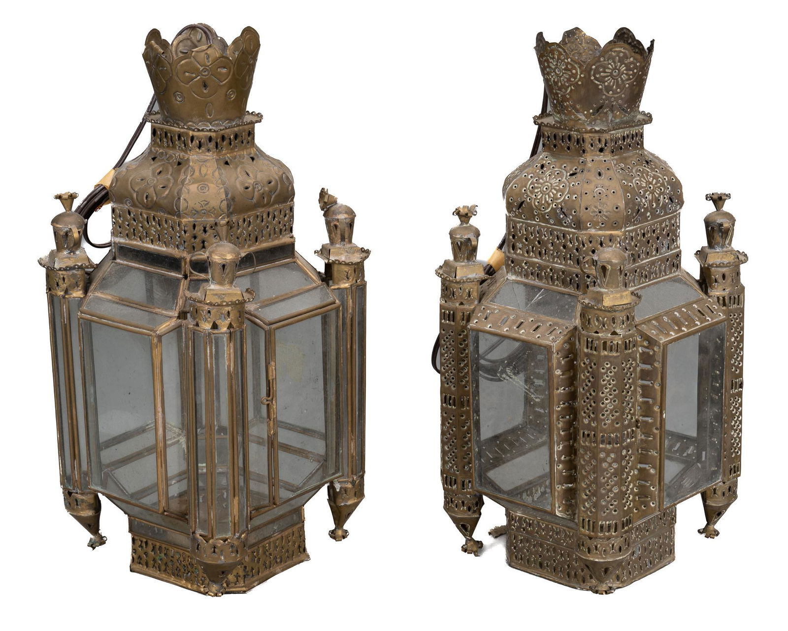 Pair of Punched Tin Lanterns by Gene Byron: Pair of punched tin lanterns, by Gene Byron (1910-1987), with punched and tooled motifs, glass door and panels, marked on interior of crest height 19 in. x width 9 in. x depth 9 in. Condition: Dents