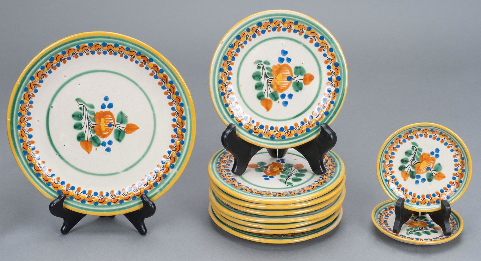 Set of (11) Mexican Majolica Plates: Set of eleven Mexican Majolica plates, with matching floral motif, to include plates of various sizes, marked "Mexico" height 1 in. x diameter 10 in. / largest Provenance: Property from a down