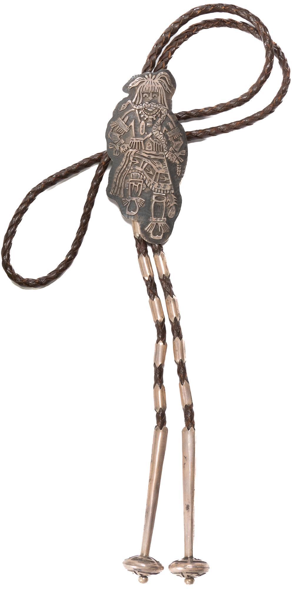 Vintage Bolo Tie: Vintage bolo tie, braided brown leather cord, bolo slide depicting a Native American holding a snake in his mouth, hogan style bolo tips with saucer shaped ends, initials etched on back of slide; incl