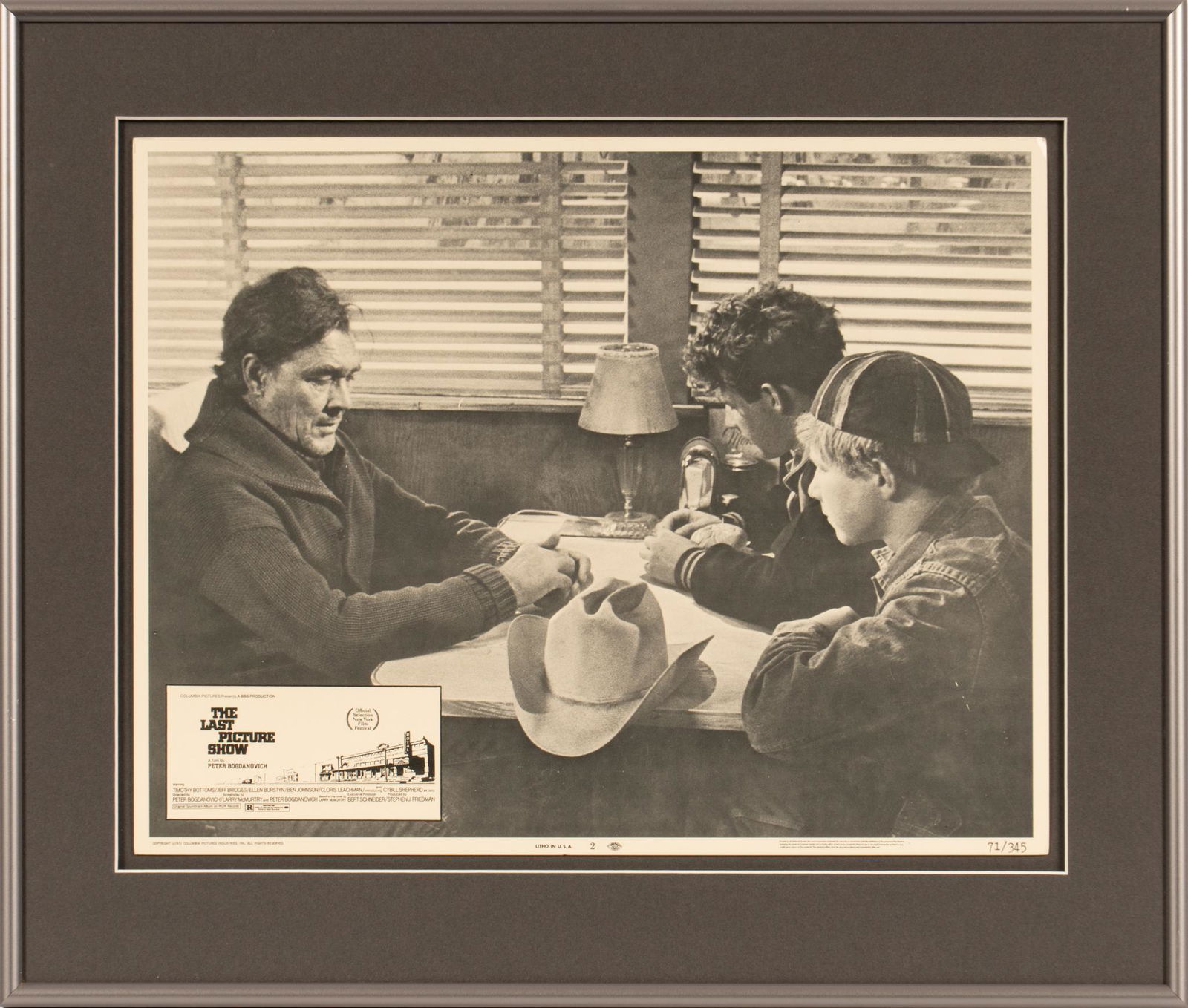 The Last Picture Show Lobby Card: Framed lobby card advertising Larry McMurtry's 1971 screenplay "The Last Picture Show", portraying a scene featuring Ben Johnson, Timothy Bottoms and Sam Bottoms, edition 71/345, includes