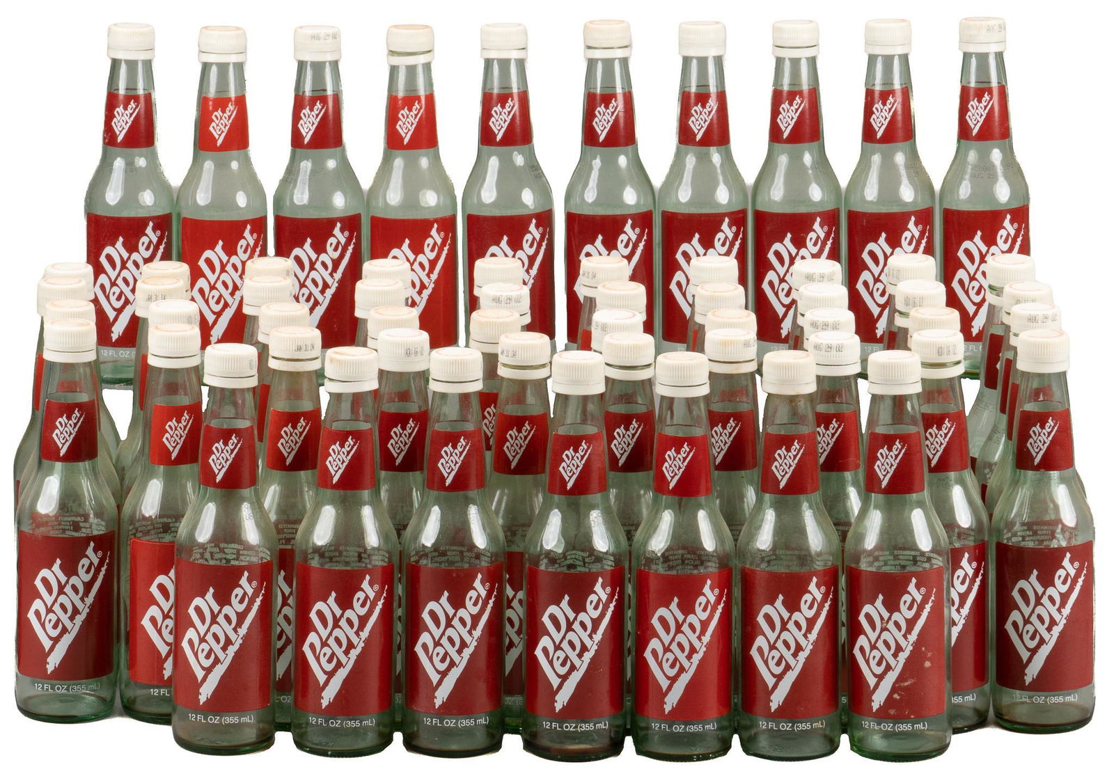 Group of (57) Vintage Dr. Pepper Bottles: Group of fifty-seven empty vintage Dr. Pepper bottles, 12 fl. oz., green glass, plastic screw caps, red paper labels; includes Certificate of Authenticity: Estate of author Larry McMurtry, from his Ar