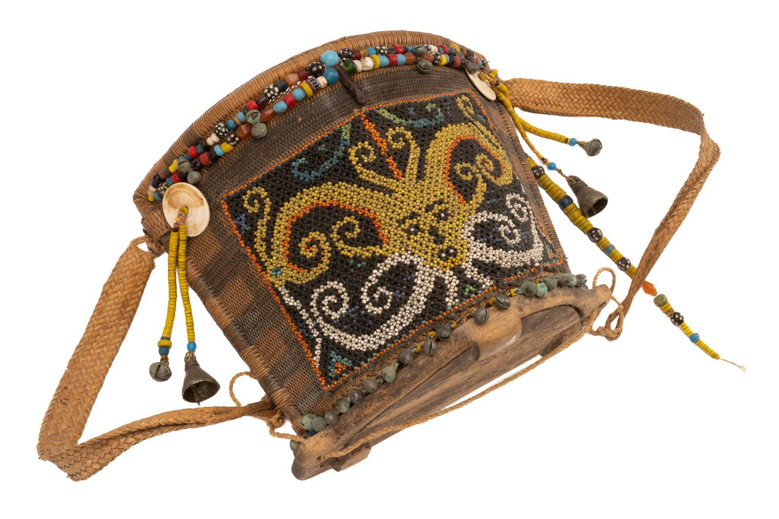 Dayak Borneo Baby Carrier: Dayak Borneo baby carrier, handmade, woven rattan body with wood base, two plaited straps, with central yellow and white beaded design of a spiritual figure used for protection, decorated with colorfu