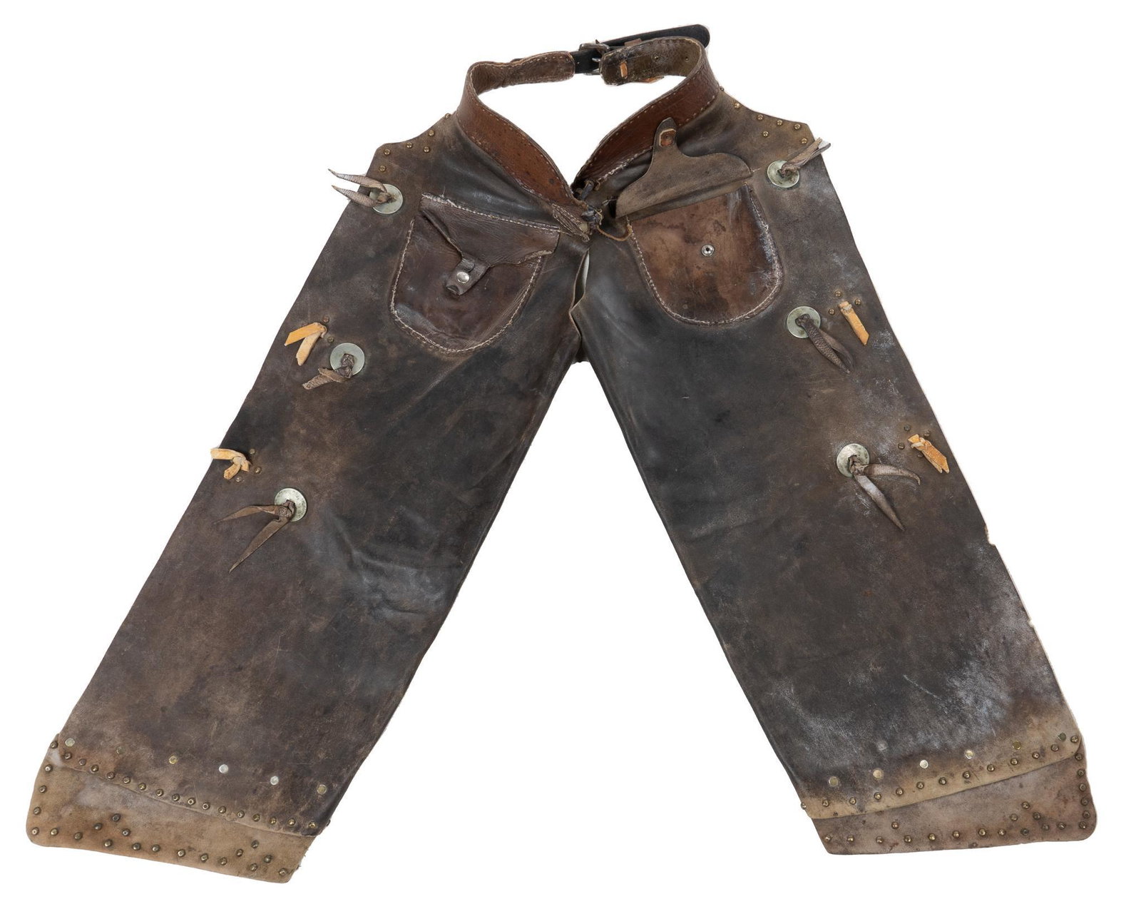 Early 20th C. Texas Cowboy Chaps: Texas cowboy brown leather chaps, two front pockets with snap buttons, six conchos, metal stud detailing throughout, clip leg closures length 36 in. x width 13 in. / flat waist width Provenance: an Al