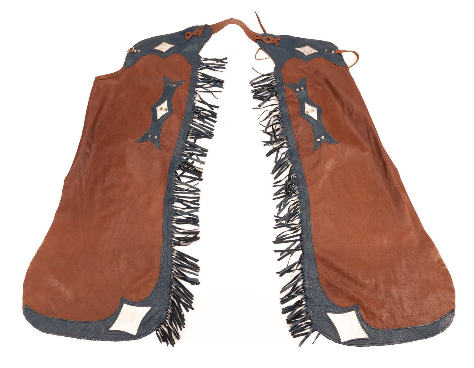 Modern Show Chaps: Modern show chaps, with blue and white stitched leather geometric motifs, on red background, blue fringe length 40 in. Provenance: An Alamo Heights, Texas collection We happily provide seamless shippi