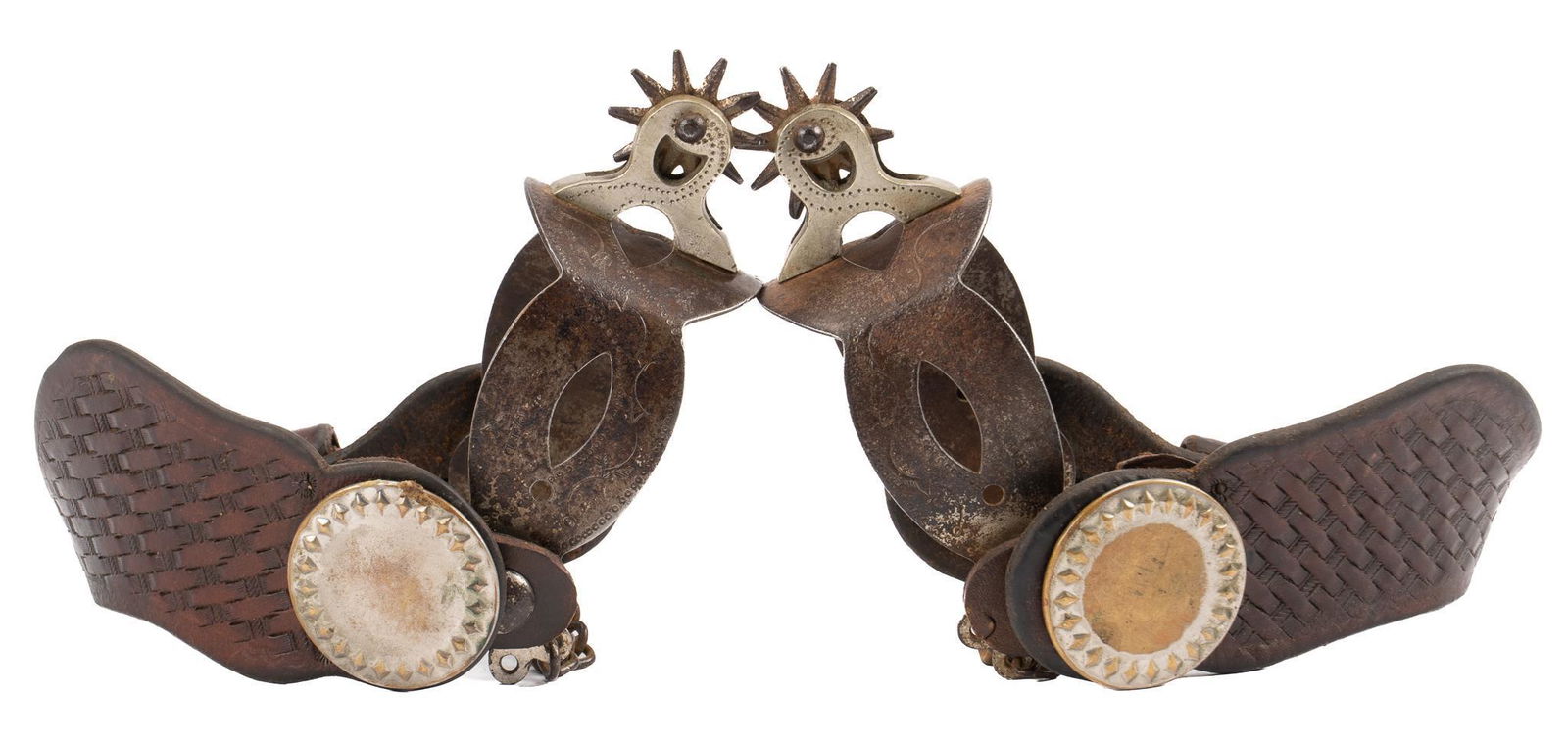 Rare August Buermann Texas Trail Drive Era Cowboy Spurs: Rare August Buermann Texas Trail Drive Era cowboy spurs, perforated steel heel band, engraved vine motif, ten point rowel, spur chain, tooled leather heel strap with conchos, marked "PAT'D'