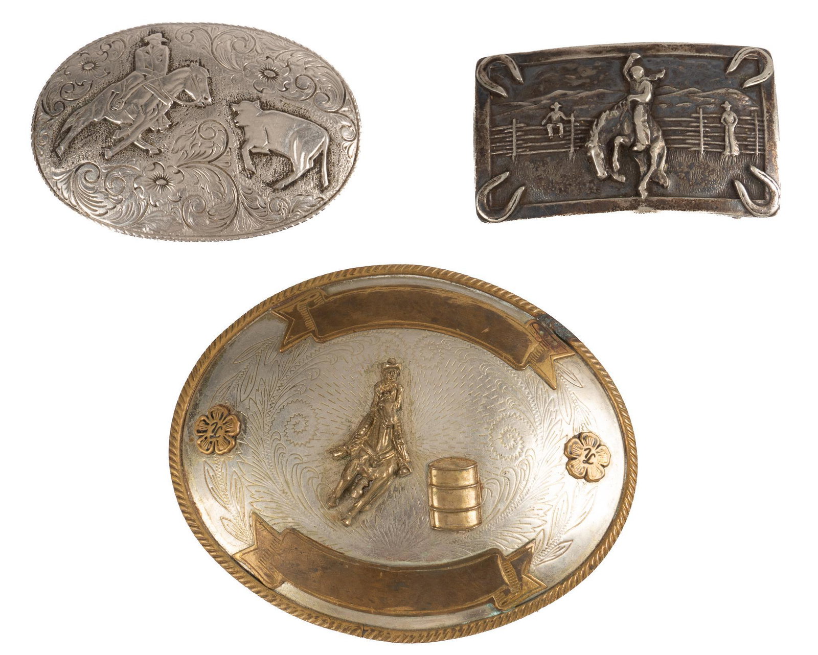 (3) Belt Buckles: Three belt buckles, all with engraved and cast rodeo motifs, featuring one German silver belt buckle, by Tony Sana, marked on back height 4 in. x width 4.5 in. x depth 0.5 in. / largest Provenance: An