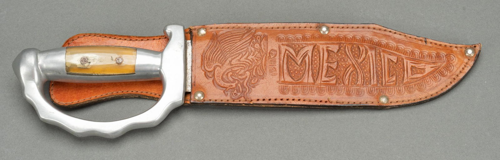 Handmade Mexican Bowie Knife W/ Leather Sheath: Handmade Mexican bowie knife with leather sheath, etched blade, and hand guard length 14 in. x width 3.5 in. x depth 1 in. Provenance: A Bulverde, Texas collection We happily provide seamless shipping