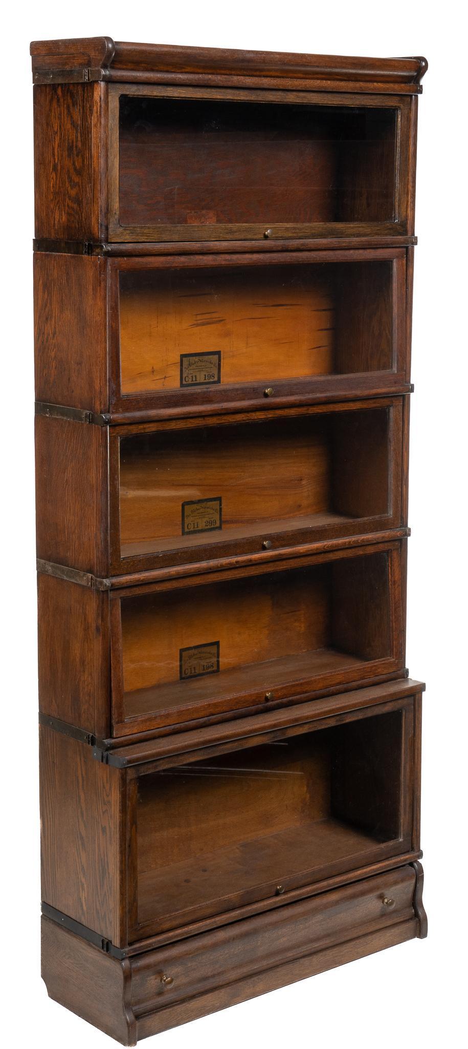 Globe-Wernicke Stacking Bookcase: Globe-Wernicke stacking bookcase, with five shelving units, four size C-11 shelves, above one larger bottom shelf, hinged top opening to interior storage, all with retracting glass fronts, supported o