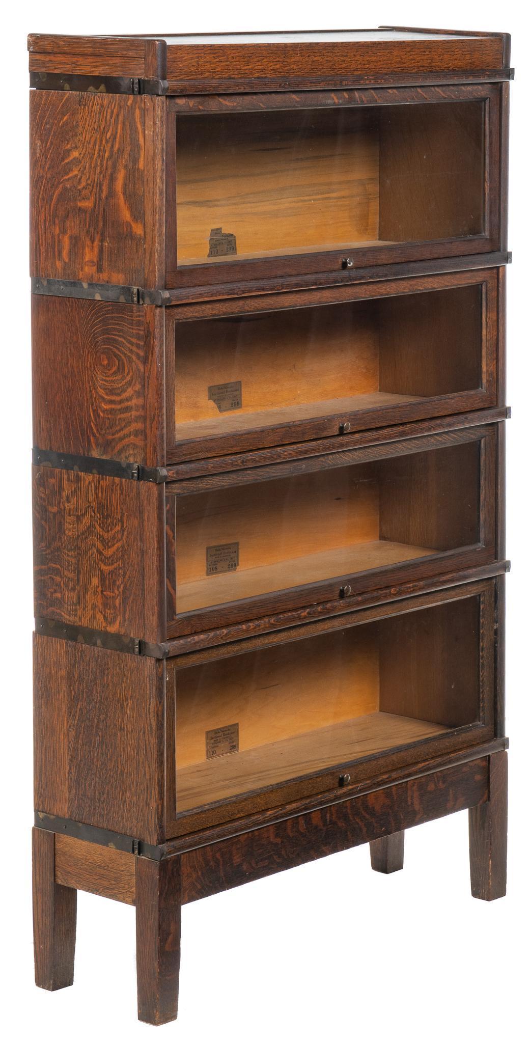 Globe-Wernicke Stacking Bookcase: Globe-Wernicke stacking bookcase, with four units, two in the 110 pattern, two in the 108, all with glass doors, labels on backs, featuring top hidden storage compartment height 59 in. x width 24 in. 