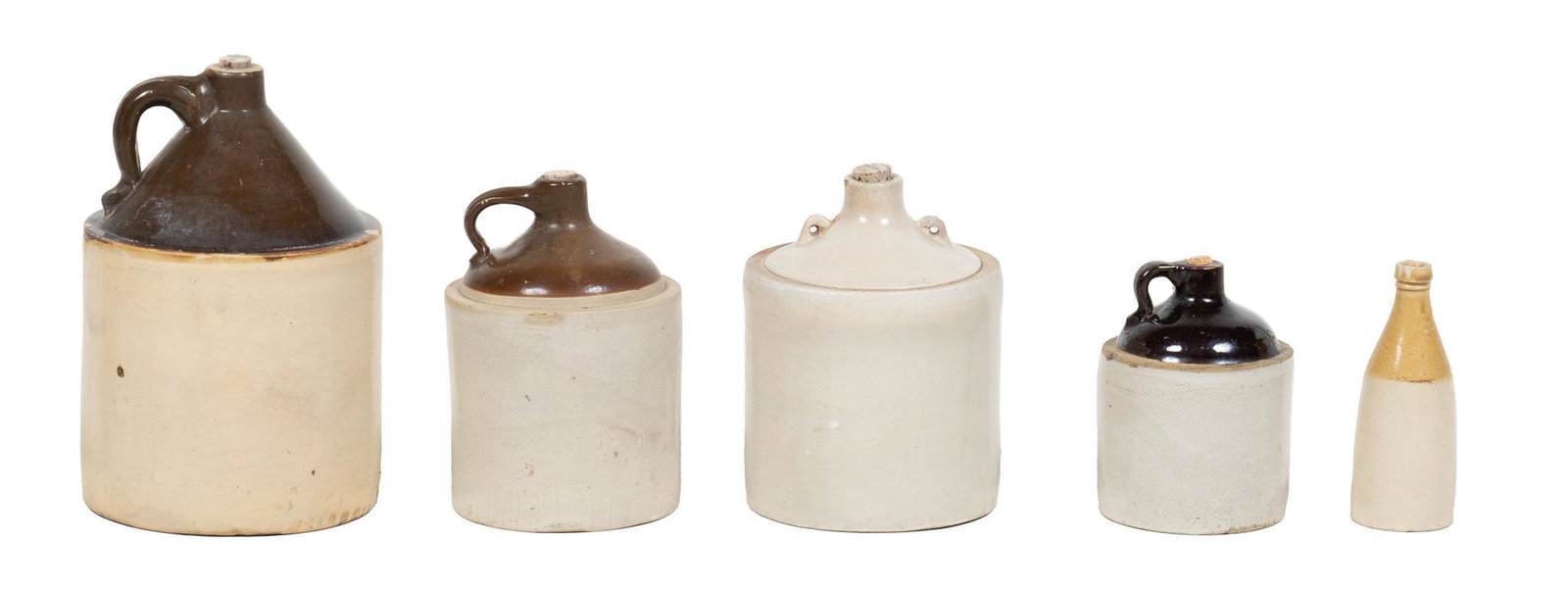 Group of (5) Stoneware Jugs and Bottle: Group of five stoneware jugs and bottle of various sizes, three with brown glazed tops and single handle including one marked "Western Stoneware", one with two small handles and white glazed t