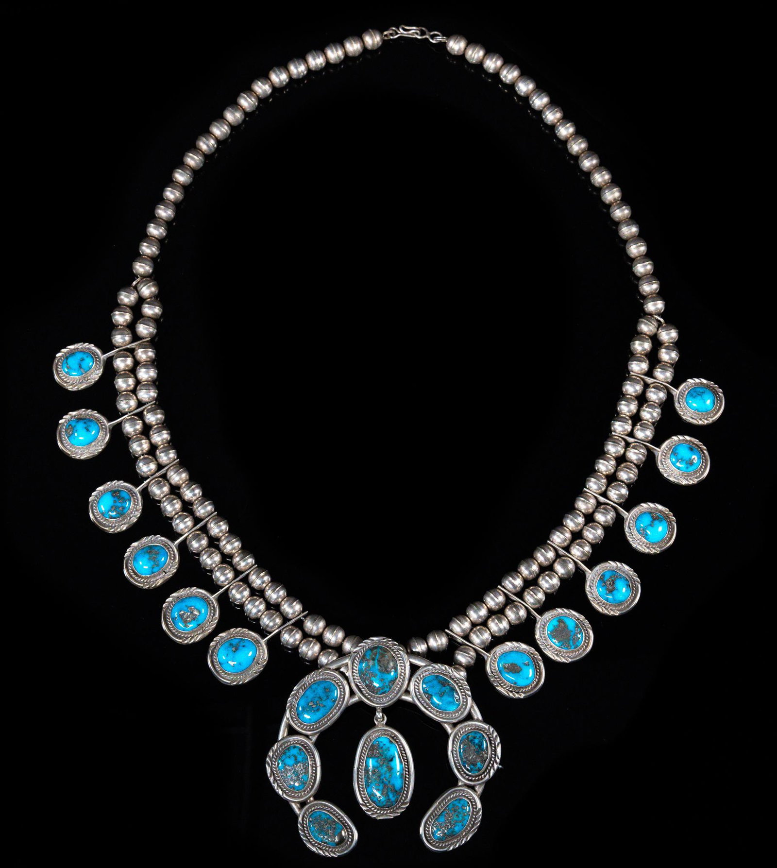 Vintage Native American Silver & Turquoise Squash Blossom: Vintage Native American (Navajo) sterling silver and turquoise squash blossom necklace, presented on a beaded chain with central raja Provenance: A Gamaliel, Arkansas collection We happily provide sea