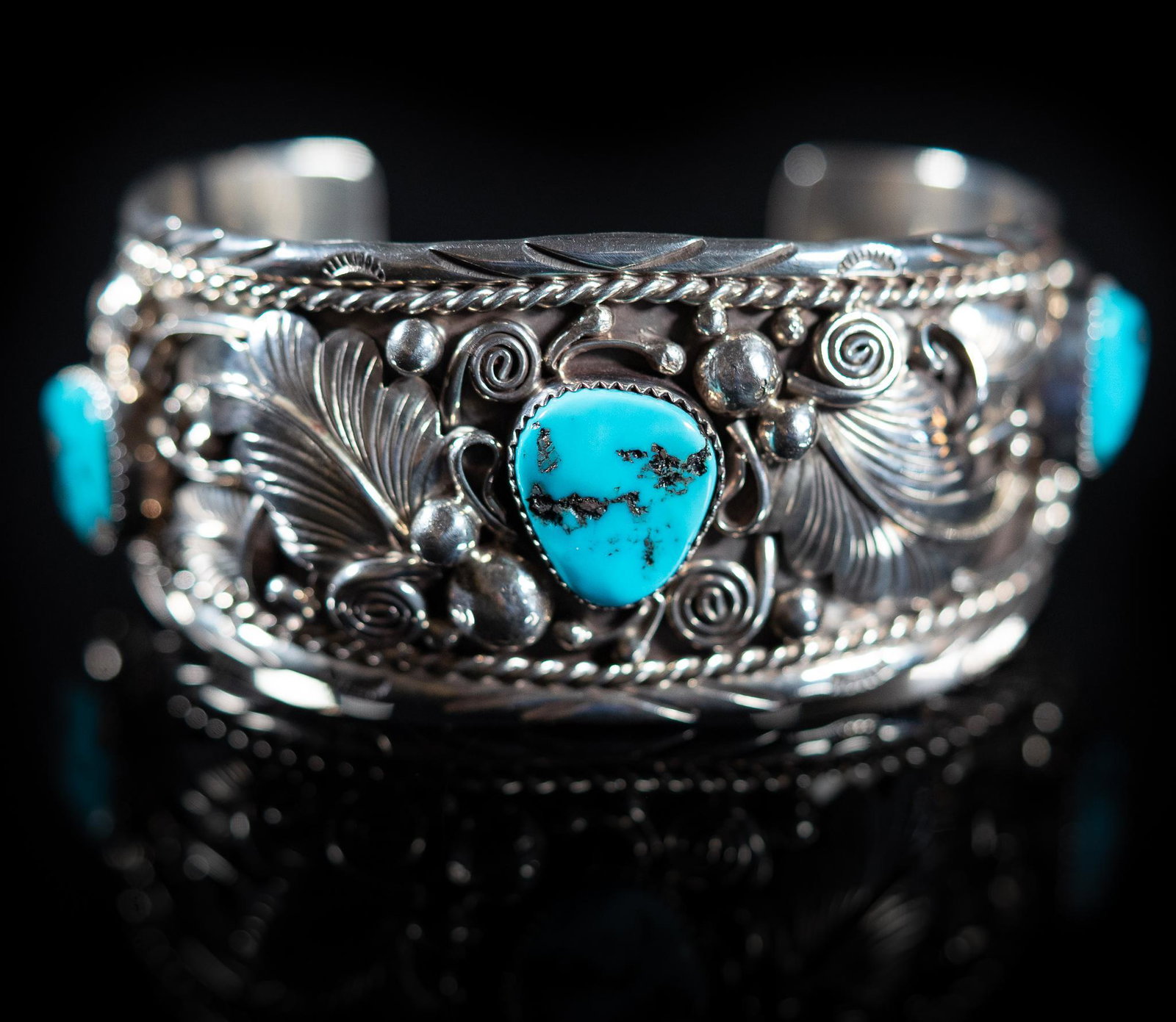Navajo Big Sterling Silver Turquoise Cuff Bracelet: Navajo big men's sterling silver turquoise cuff bracelet for a larger wrist, cuff with detailed hand applied feather, bead, and scroll design, three turquoise nuggets, marked "Sterling", s