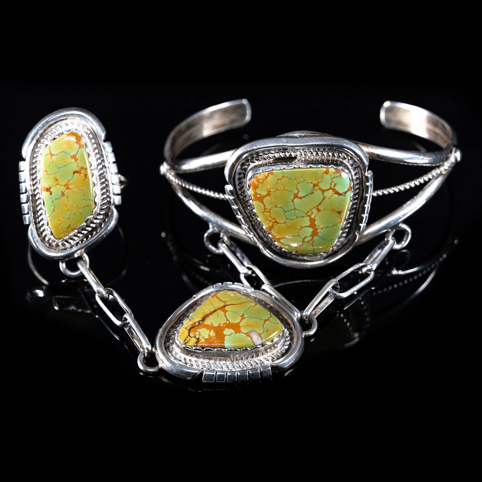 Charles Johnson Navajo Prison Bracelet: Charles Johnson Navajo turquoise and sterling silver hand chain prison bracelet, having matched turquoise stone throughout, includes ring, signed by artisan and marked 'sterling' Provenance: A