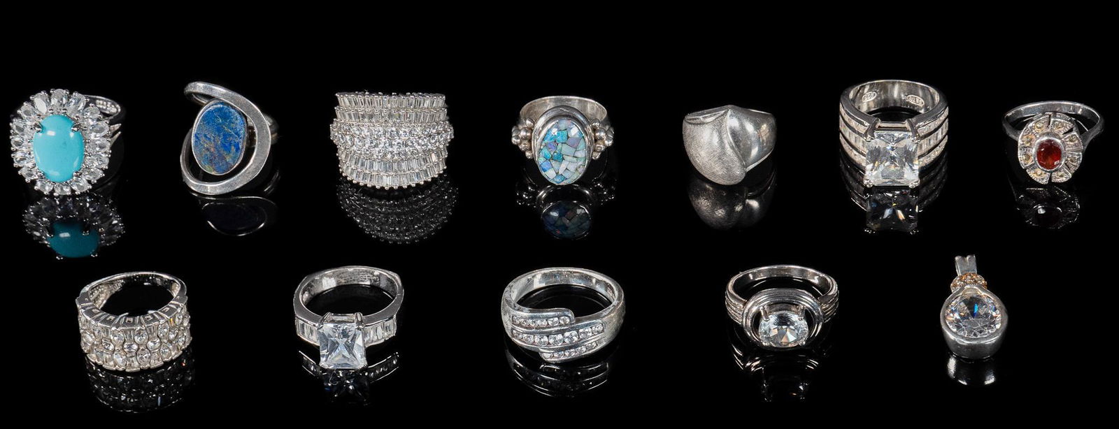 Group of (11) Sterling Silver Rings and (1) Pendant: Group of eleven sterling silver rings, in a variety of styles and settings, also to include a sterling silver pendant, all marked Total weight: 81.2 grams Provenance: A San Antonio, Texas collection