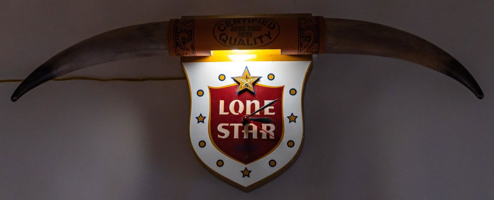 Vintage Lone Star Beer Advertising Clock: Vintage wall hanging Lone Star Beer advertising clock, having shaped crest as the clock with Lone Star logo, below faux longhorns with slogan reading "Certified Lone Star Beer Quality", circa