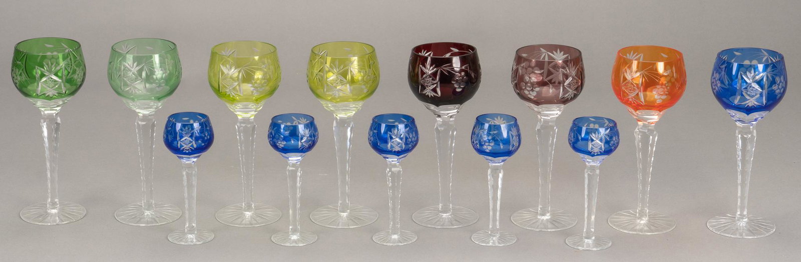 (13) Cut to Clear Glasses: Group of thirteen (13) cut to clear stemware glasses, including eight (8) tall wine glasses of varying colors and a matched set of five (5) cobalt cordial glasses height 8.5 in. x diameter 3.5 in. Pro