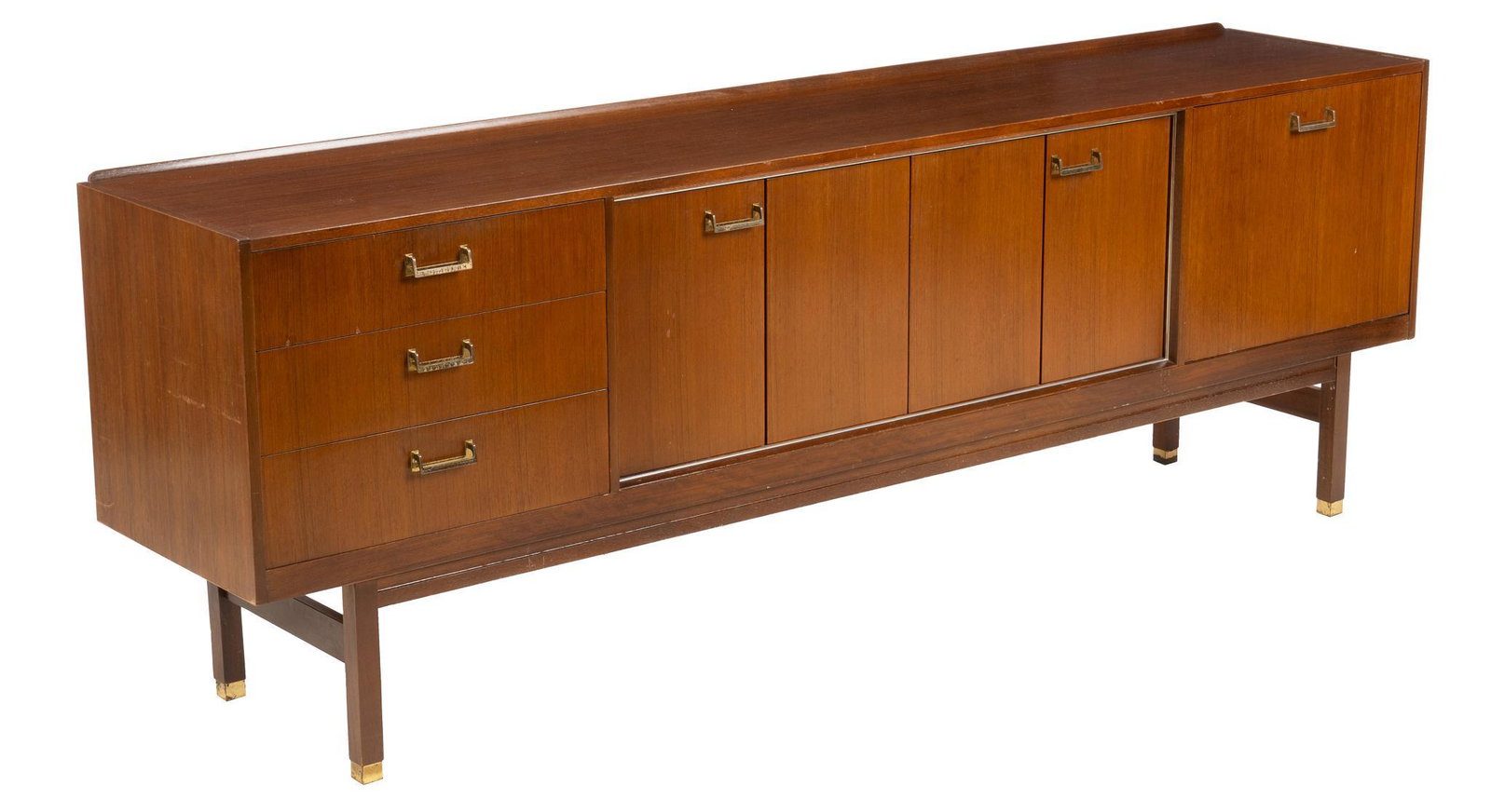 English Mid-Century Credenza: English Mid-Century credenza, two drop-front compartments that open to a shelved interior, three drawers, all having brass drop handles, raised on block supports height 30.5 in. x width 87 in. x depth