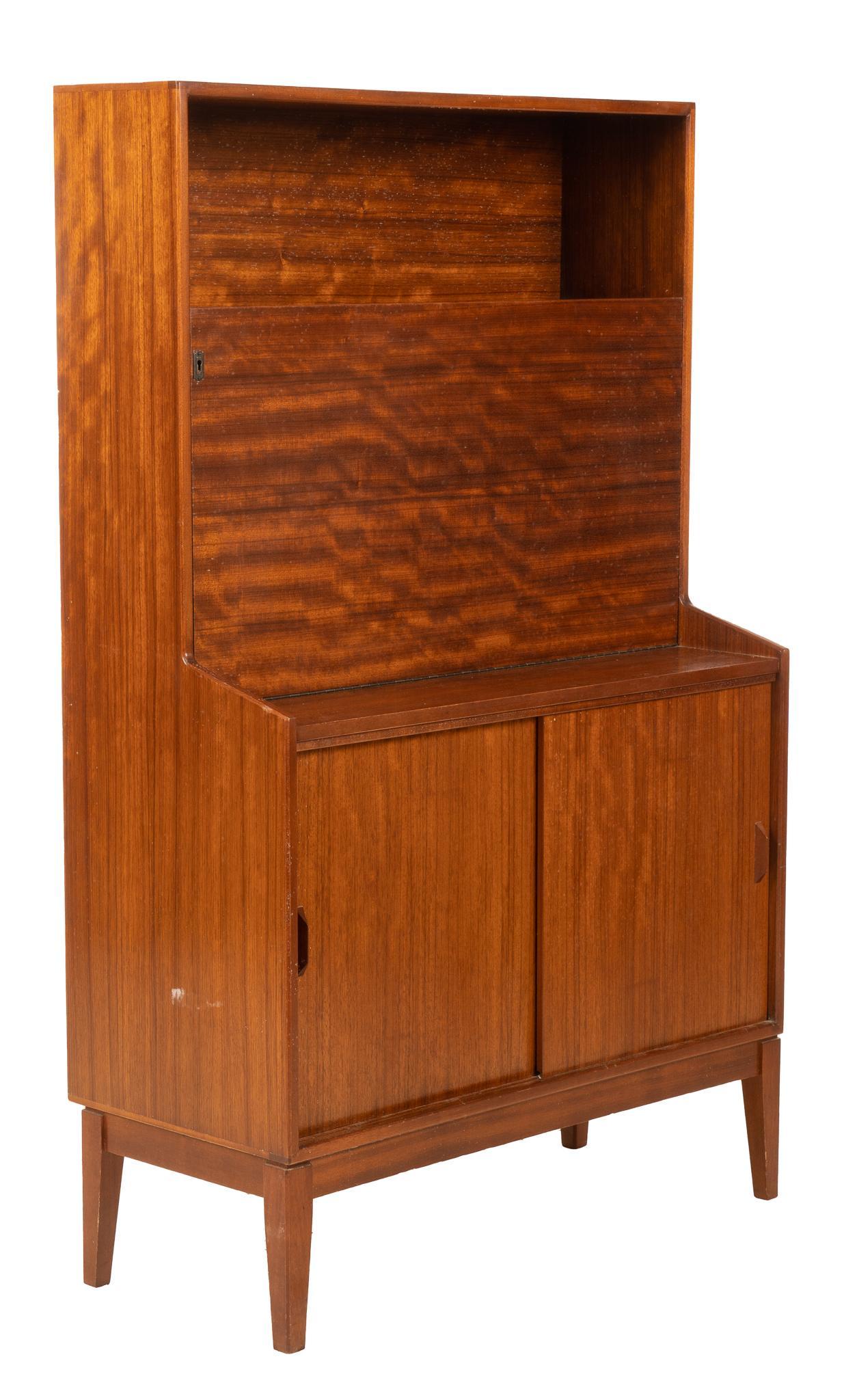 Mid-Century Cocktail Cabinet: Mid-Century step-back cocktail cabinet, with upper shelf, over sliding cabinet door, opening to mirror backed storage, height 58 in. x width 36 in. x depth 16 in. We happily provide seamless shipping 