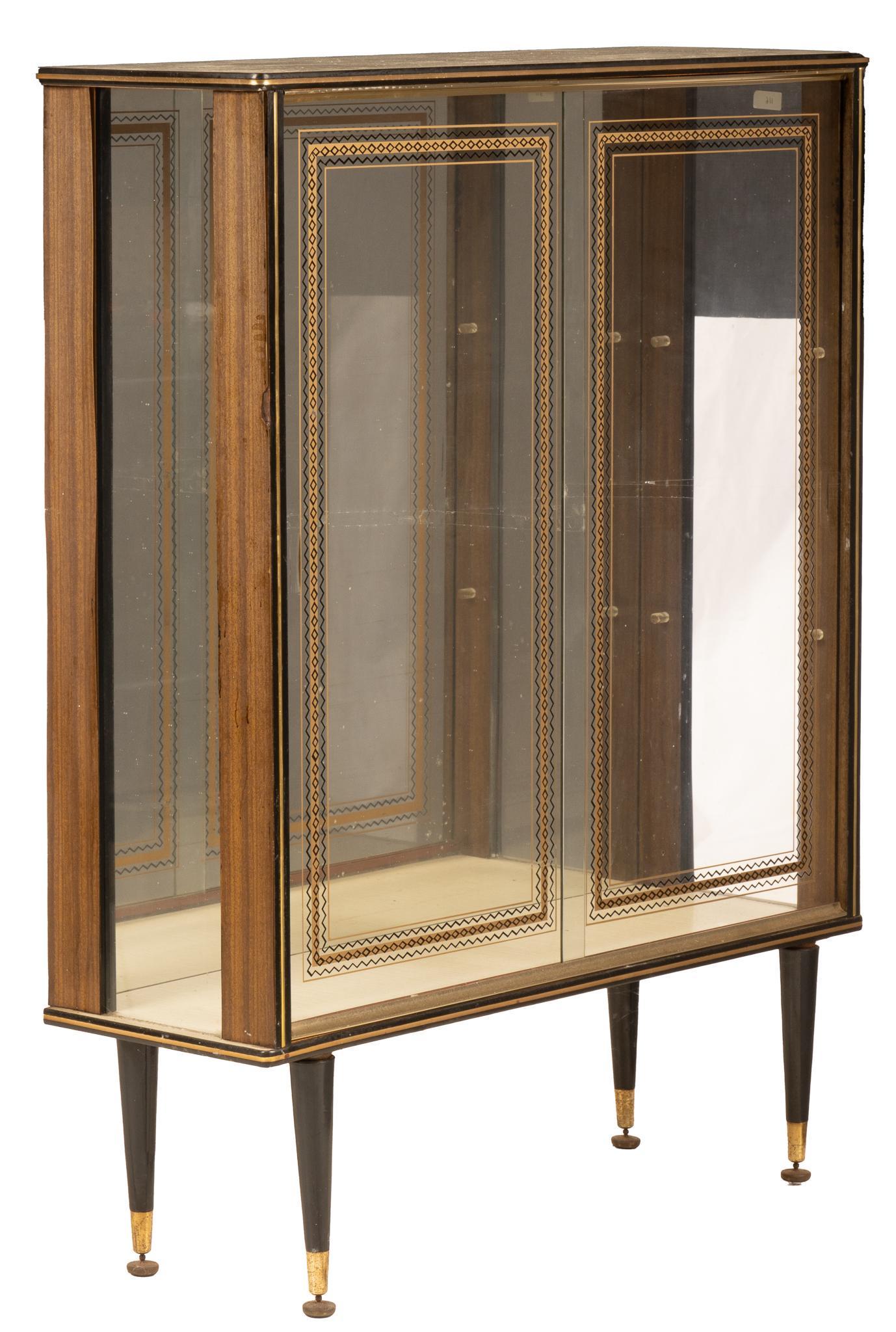 Mid-Century Mirror-Backed Cabinet: Mid-Century mirror backed cabinet, with sliding glass panels, featuring art deco style designs, opening to mirrored interior, supported on pin legs, ending in gliders height 46 in. x width 36 in. x d