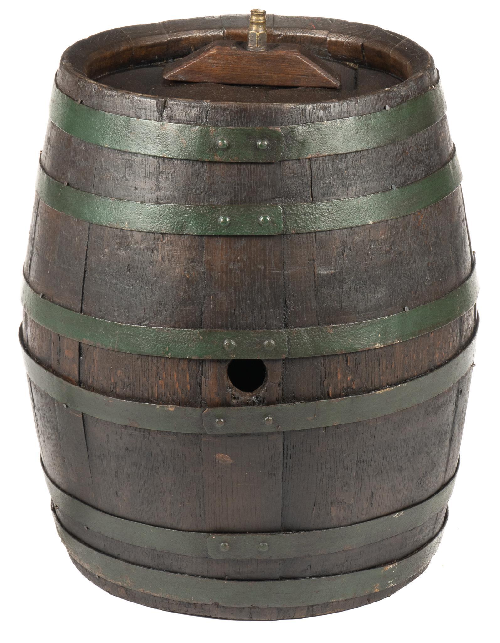Banded Barrel: Banded barrel, with dark finish, painted green iron banding, top and side spigot, marked height 27 in. x width 23 in. x depth 23 in. We happily provide seamless shipping services on everything we s