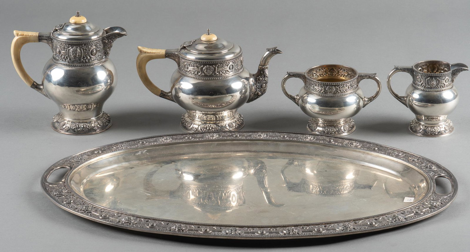 4-Piece Vintage Wakely and Wheeler Sterling Silver Tea Set with Tray: Four piece vintage Wakely and Wheeler (London) sterling silver tea set, includes tea pot, pitcher, creamer and sugar bowl, tea pot and pitcher with bone handles and finials, marked on sides, includes 