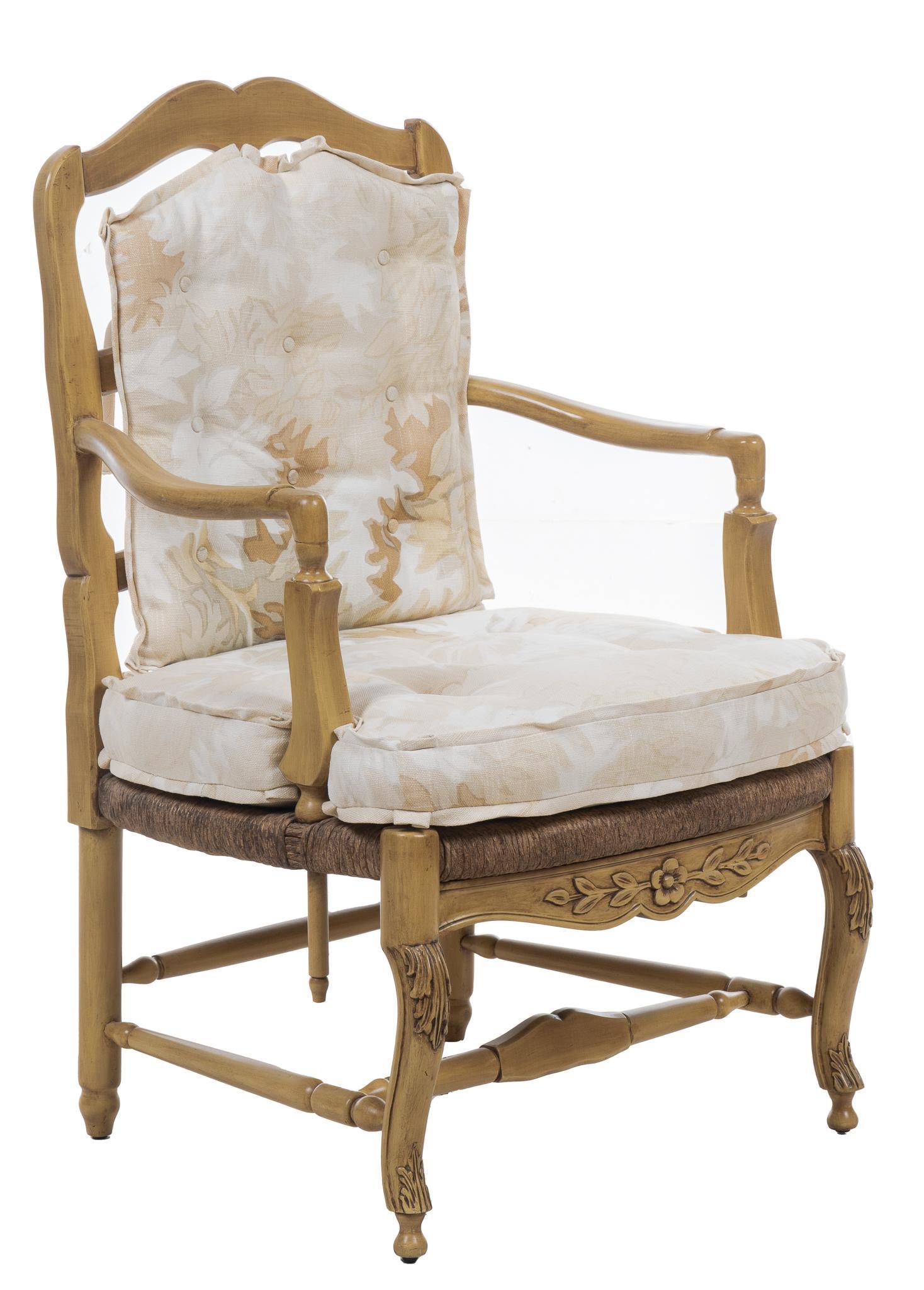 French Provincial Armchair: French Provincial armchair, with wood frame, rush seat, floral motif on front seat rail, fabric upholstered cushions with subtle leaf pattern, stretchered cabriole and turned legs height 41.5 in. x wi
