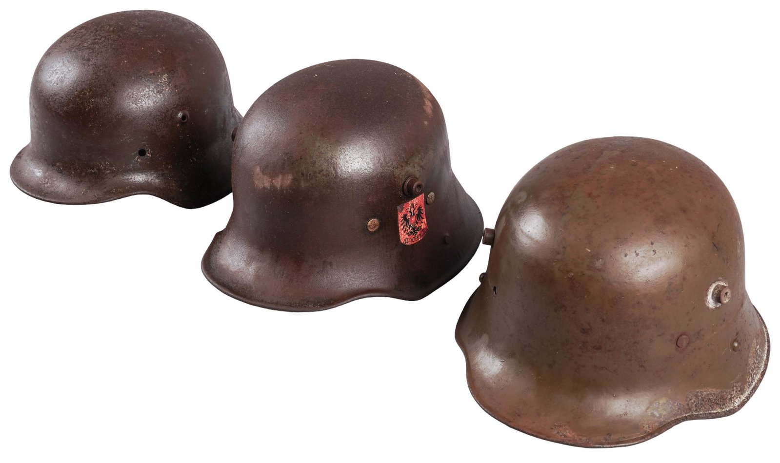 3 German and Austrian WWI WWII helmets: Includes 1- Austrian WWI M16 Helmet w/ liner 2- Austrian WWI M16 Helmet w/o liner 3- German WWII M40 Helmet w/o liner Condition 1-Good: helmet has spots of paint loss and handling marks, liner is in g