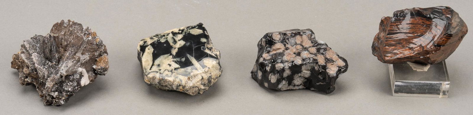 Assortment of (4) Rough Stones: Assortment of four (4) rough stones, chalcopyrite, black tourmaline mahogany obsidian, snowflake obsidian height 1.5 in. x width 3.25 in. x depth 3 in. / largest Provenance: A Fredericksburg, Texas