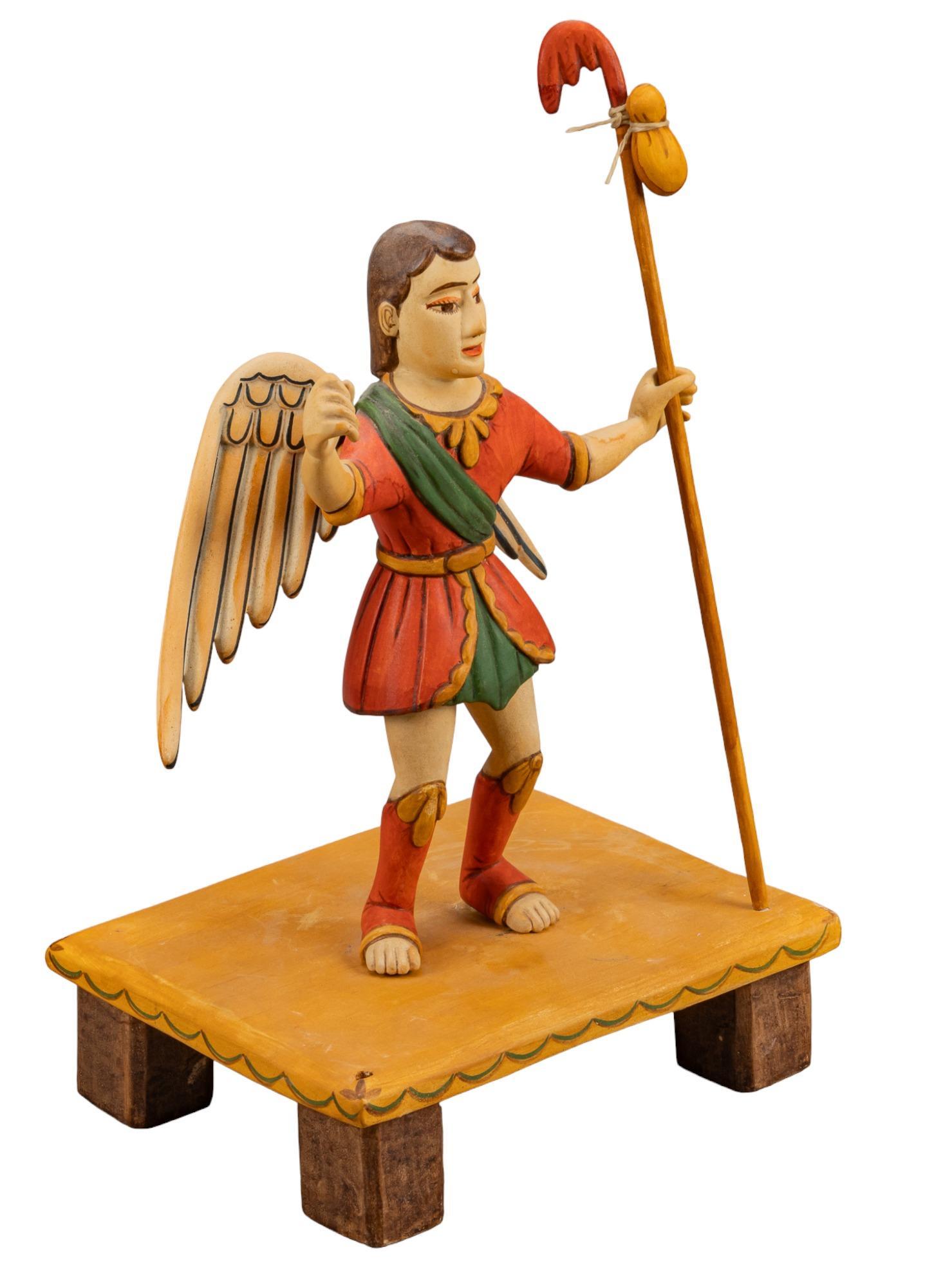Frankie Nazario Lucero, San Rafael: Frankie Nazario Lucero (New Mexico, 20th Century) carved and painted wooden depiction of Saint Raphael holding staff on raised platform, signed height 13 in. x width 9 in. x depth 7 in. Provenance: