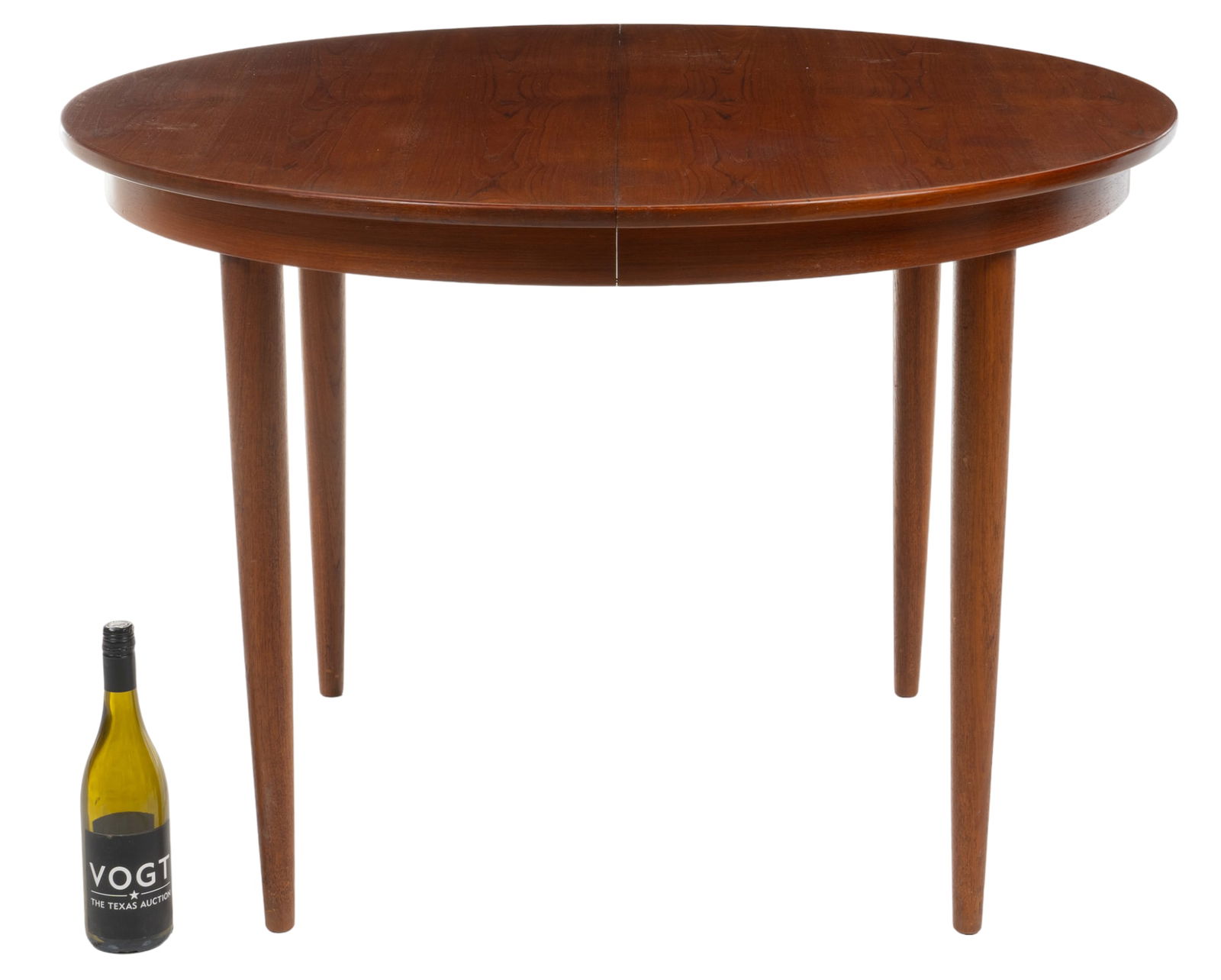 Mid-Century Extending Dining Table: Mid-Century extending dining table, with round top, housing leaf inserts, supported on pin legs height 29 in. x width 43.5 in. x depth 43.5 in. Provenance: A San Antonio, Texas collection We happi