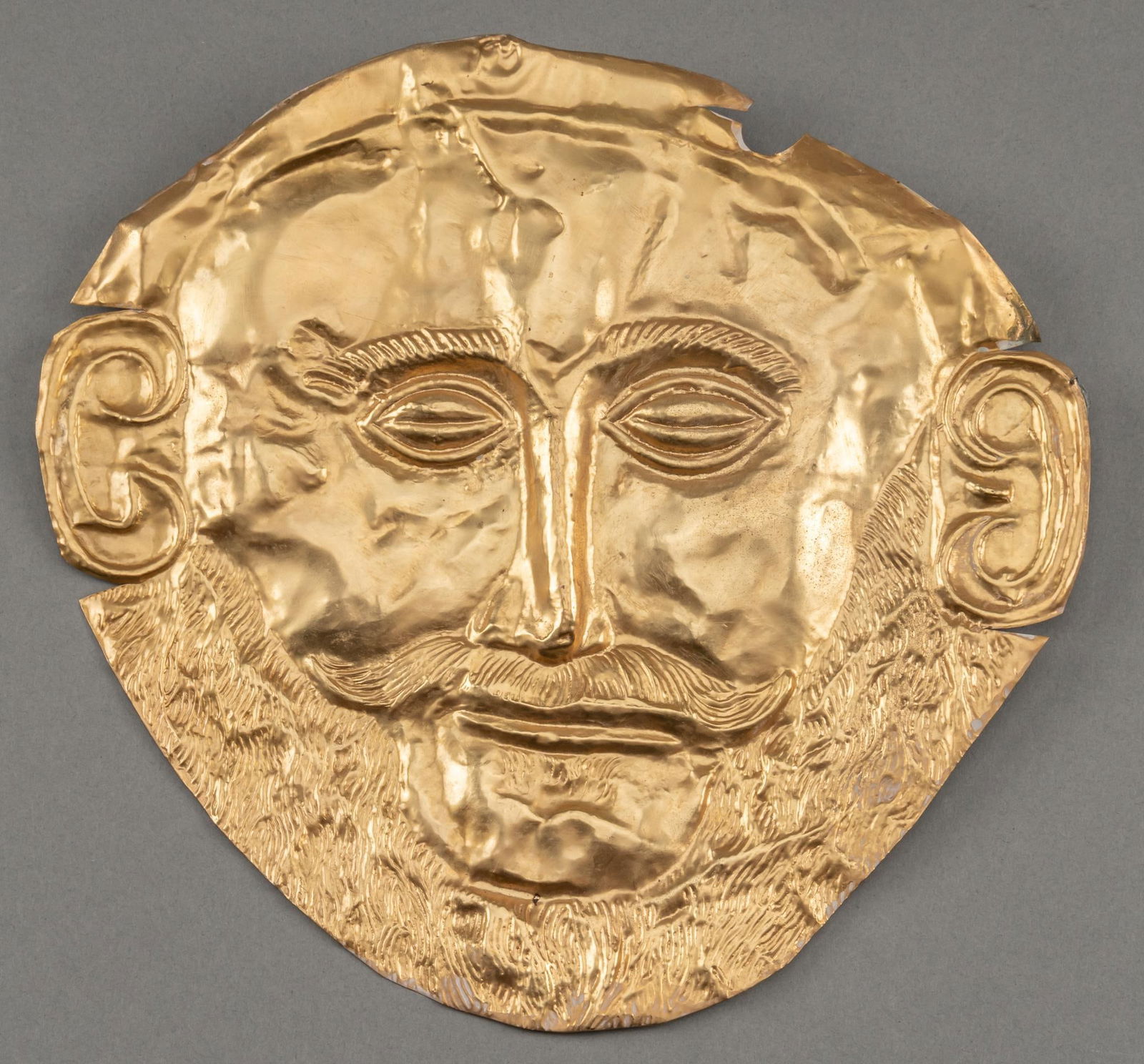Replica Mask of Agamemnon: Replica copper alloy mask of Agamemnon height 10 in. x width 9.5 in. Provenance: Property from a Mexico City, Mexico mansion We happily provide seamless shipping services on everything we sell. Ple