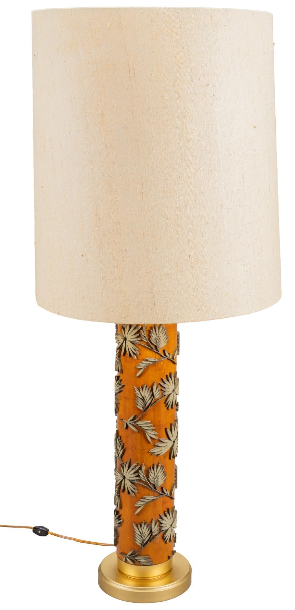 Carved Wood and Gold Metal Lamp: Carved wood and gold metal lamp, tropical leaves on orange backdrop, linen shade, gold metal bottom height 41.5 in. x diameter 18 in. Provenance: Property from the collection of a prominent San Anto