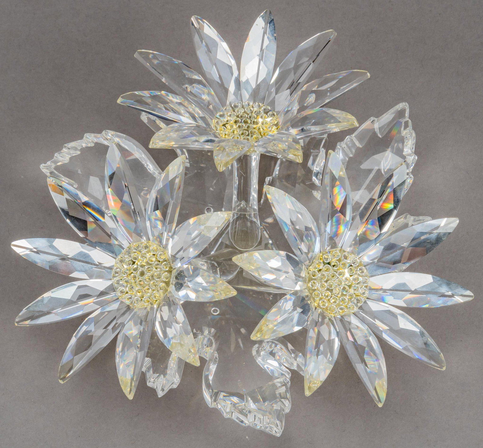 Swarovski Crystal Maxi Flower Arrangement Figurine: Swarovski crystal maxi flower arrangement figurine, designed by Michael Stamey, produced 2000 - 2008 as part of the "Secret Garden" series, features 3 faceted clear crystal flowers on a crysta