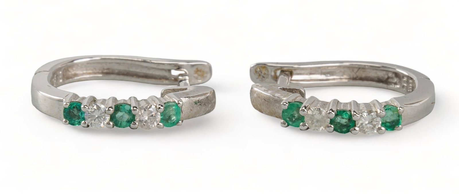 14K White Gold Emerald and Diamond Huggies: 14K white gold emerald and diamond huggies, prong set row of 3 round brilliant emeralds and 2 round brilliant diamonds, marked diameter/ 13 mm. total weight: 2.4 grams Provenance: An Castle Hills, Tex