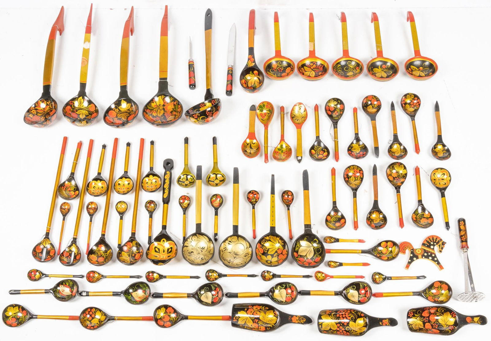 Vintage Russian Khokhloma Tableware: Large assorted collection of vintage Soviet Union-era Russian Khokhloma decorative Tableware, including plates, cups, bowls, egg cups, chargers, and spoons, featuring hand painted floral motifs in gol