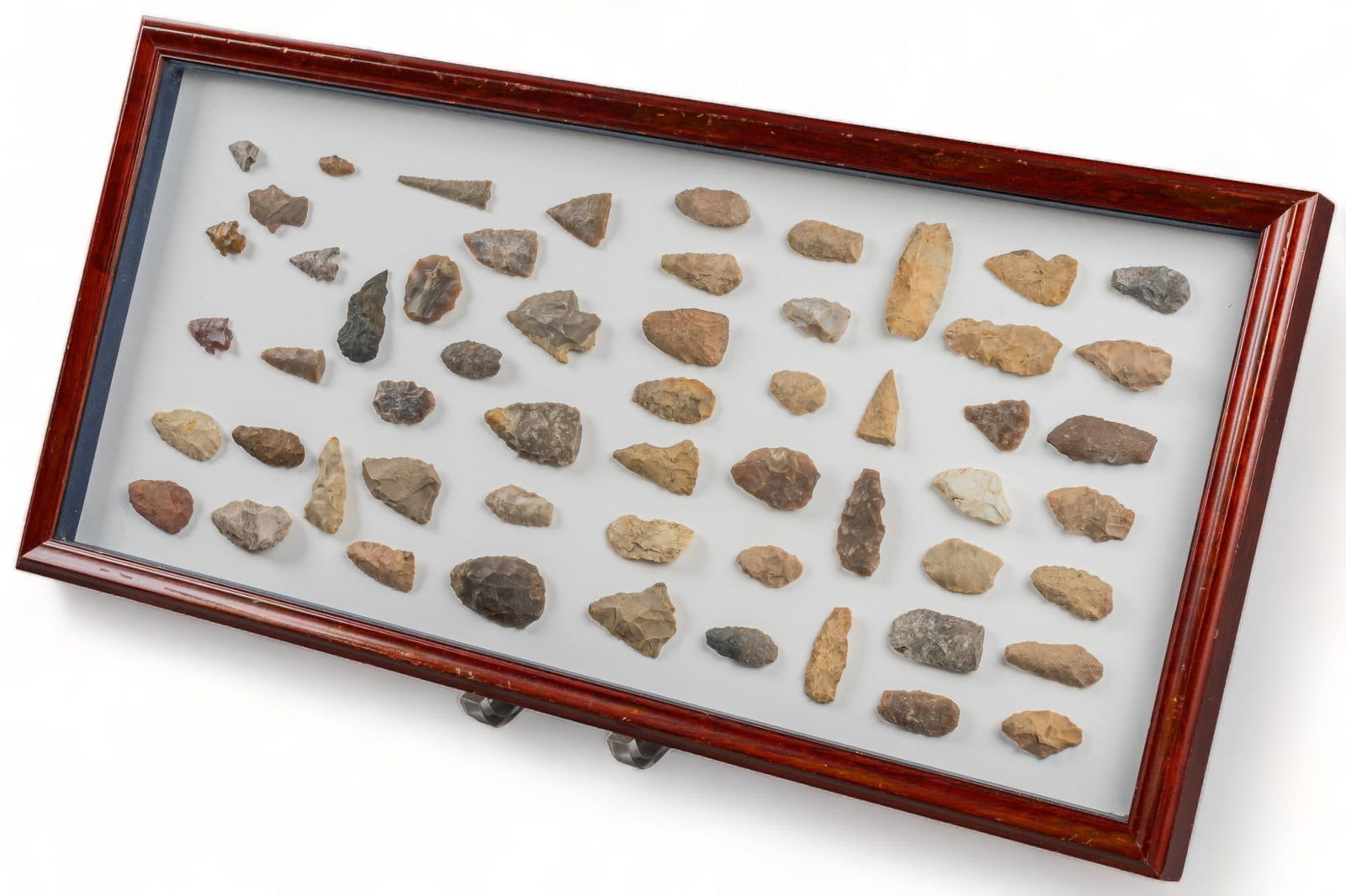 Framed Display of Archeological Tools: Framed display of archeological tools, including scrapers, and projectile points, mounted in lined display box with hinged tops height 12.5 in. x width 26.5 in. x depth 1 in. We happily provide seam