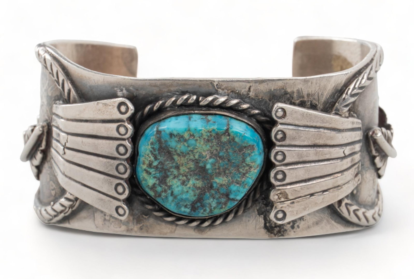 Native American Sterling Silver Turquoise Cuff: Native American sterling silver turquoise cuff, leaf, bead and rope designs, central turquoise stone circumference 7 in. width 35 mm. We happily provide seamless shipping services on everything we sel