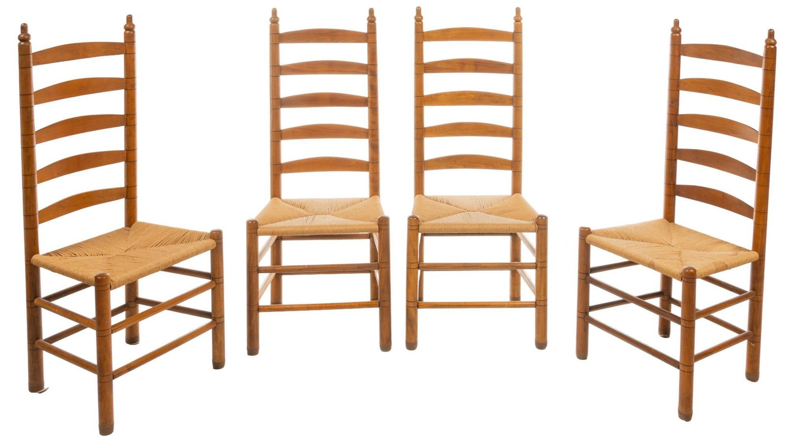 Set of (4) Rush Seat Chairs: Set of four dining chairs, with ladder backs, topped with finials, woven rush seats, supported on stretchered block legs height 47 in. x width 20 in. x depth 17 in. / each Provenance: A Comfort, Texas