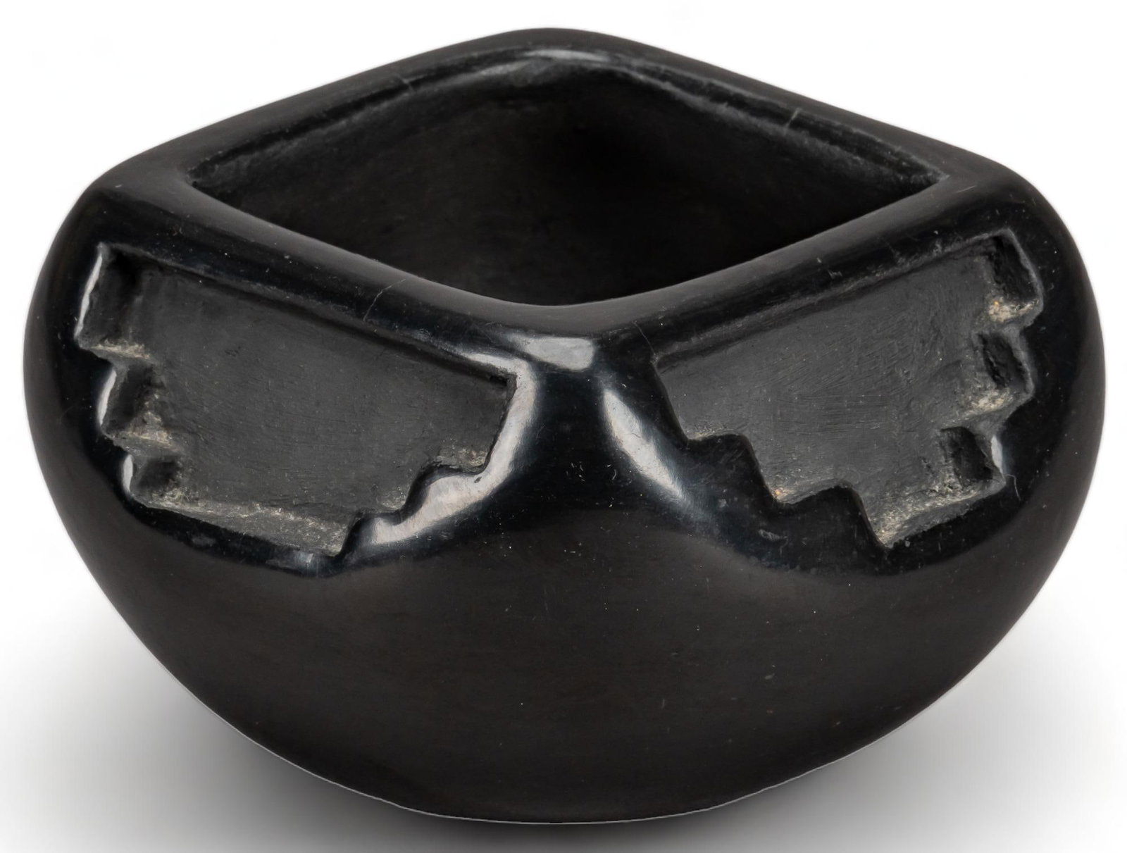 Santa Clara Carved Blackware Bowl: Santa Clara (New Mexico) polished blackware bowl, featuring carved geometric motif, signed on base height 2.5 in. x width 4.5 in. x depth 4.5 in. Provenance: The Estate of Nancy Kendall, Blanco, Texas